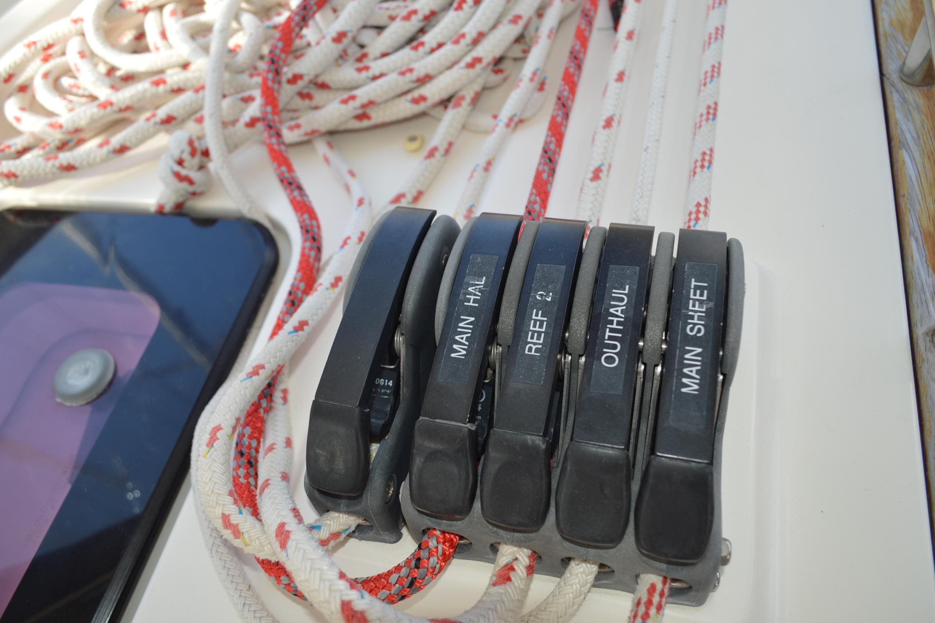 Sailing controls on a 2011 Bavaria 45 yacht, featuring labeled rope clutches.