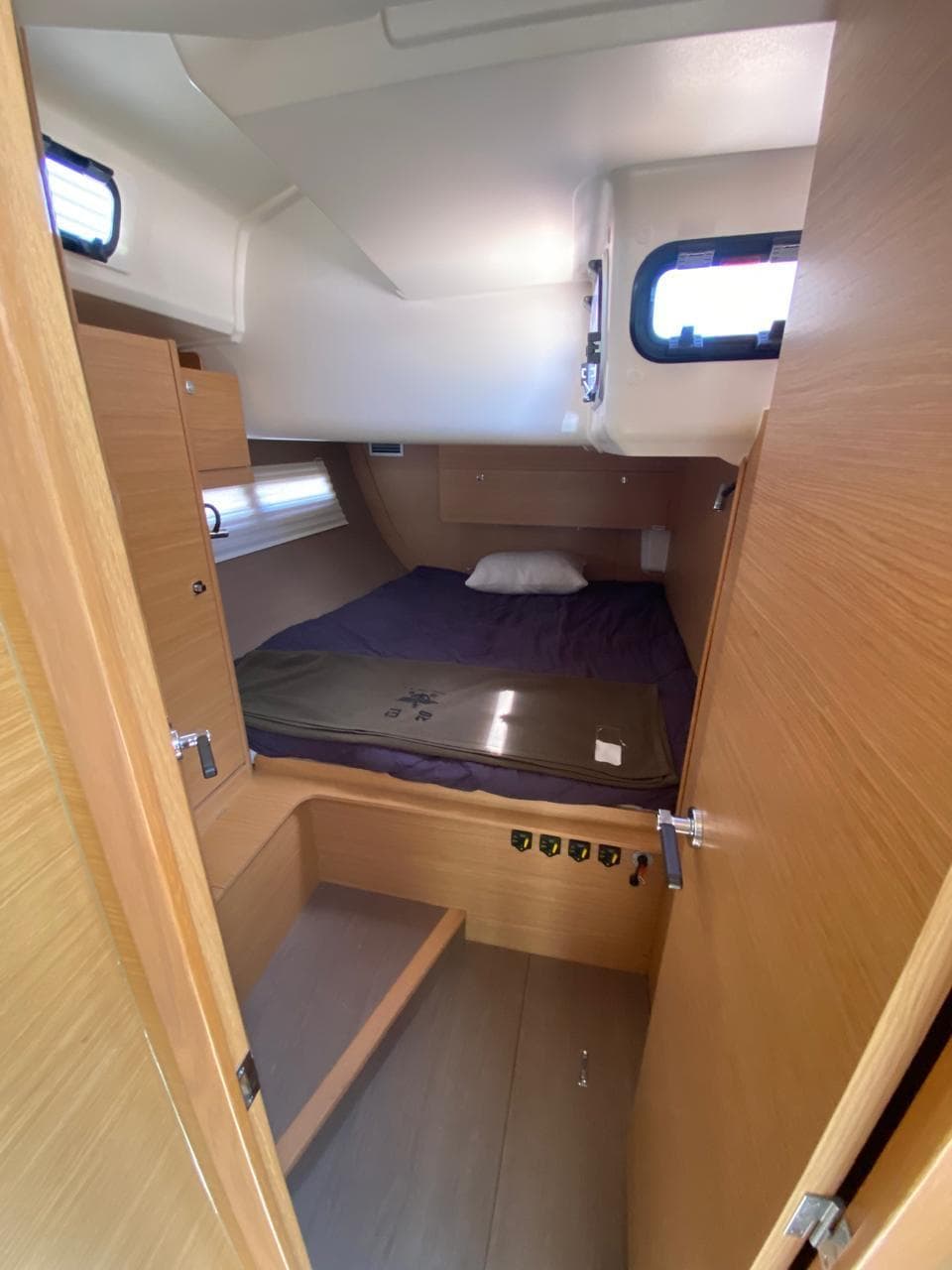 2017 Dufour Exclusive 56 yacht cabin with wooden interior and cozy bed.