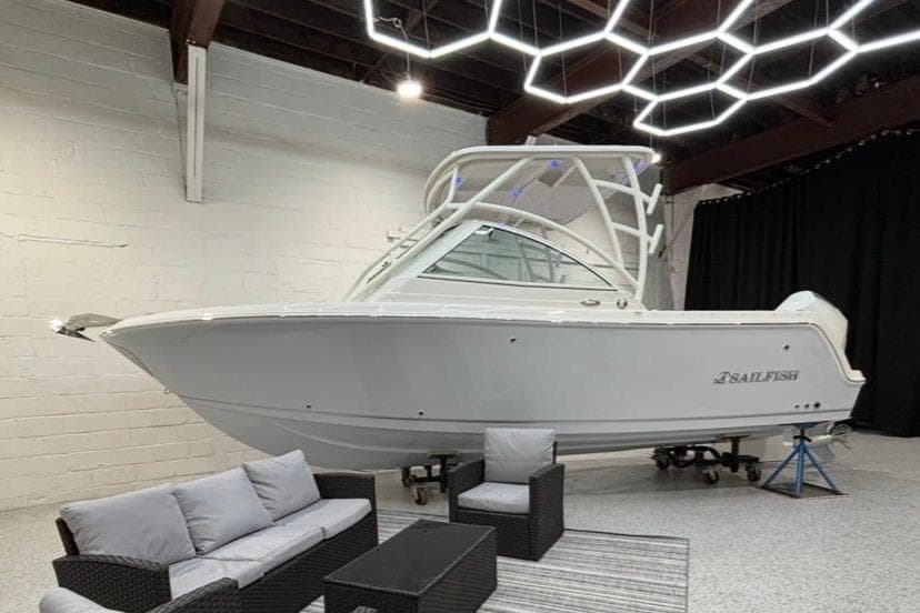2026 Sailfish 245 DC boat in modern showroom.