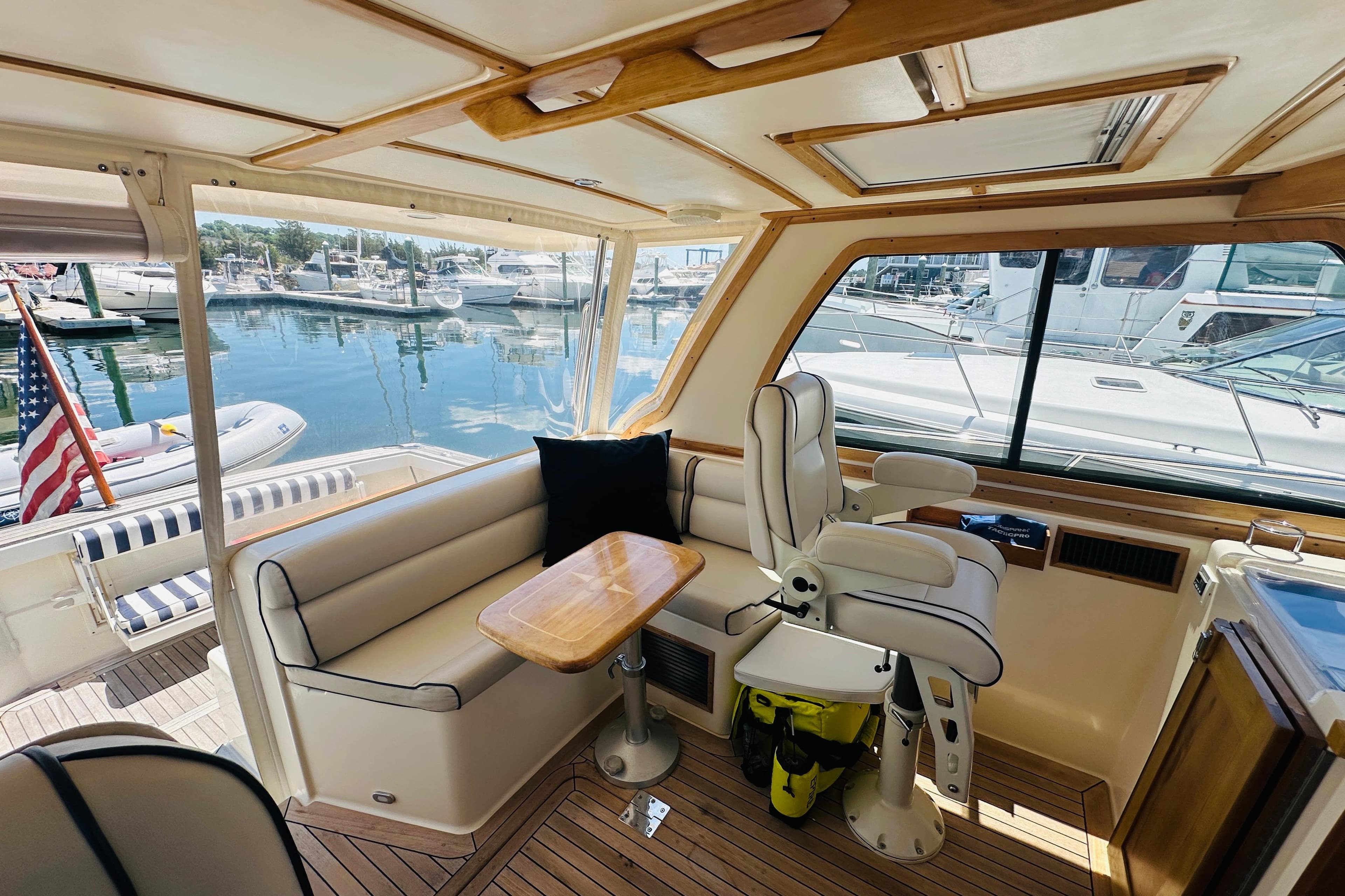 Interior of 2006 Sabre 38 Hard Top Express yacht with seating and marina view.