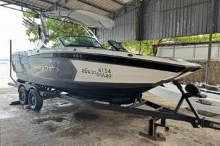 2018 MasterCraft XStar boat on trailer in covered storage area.