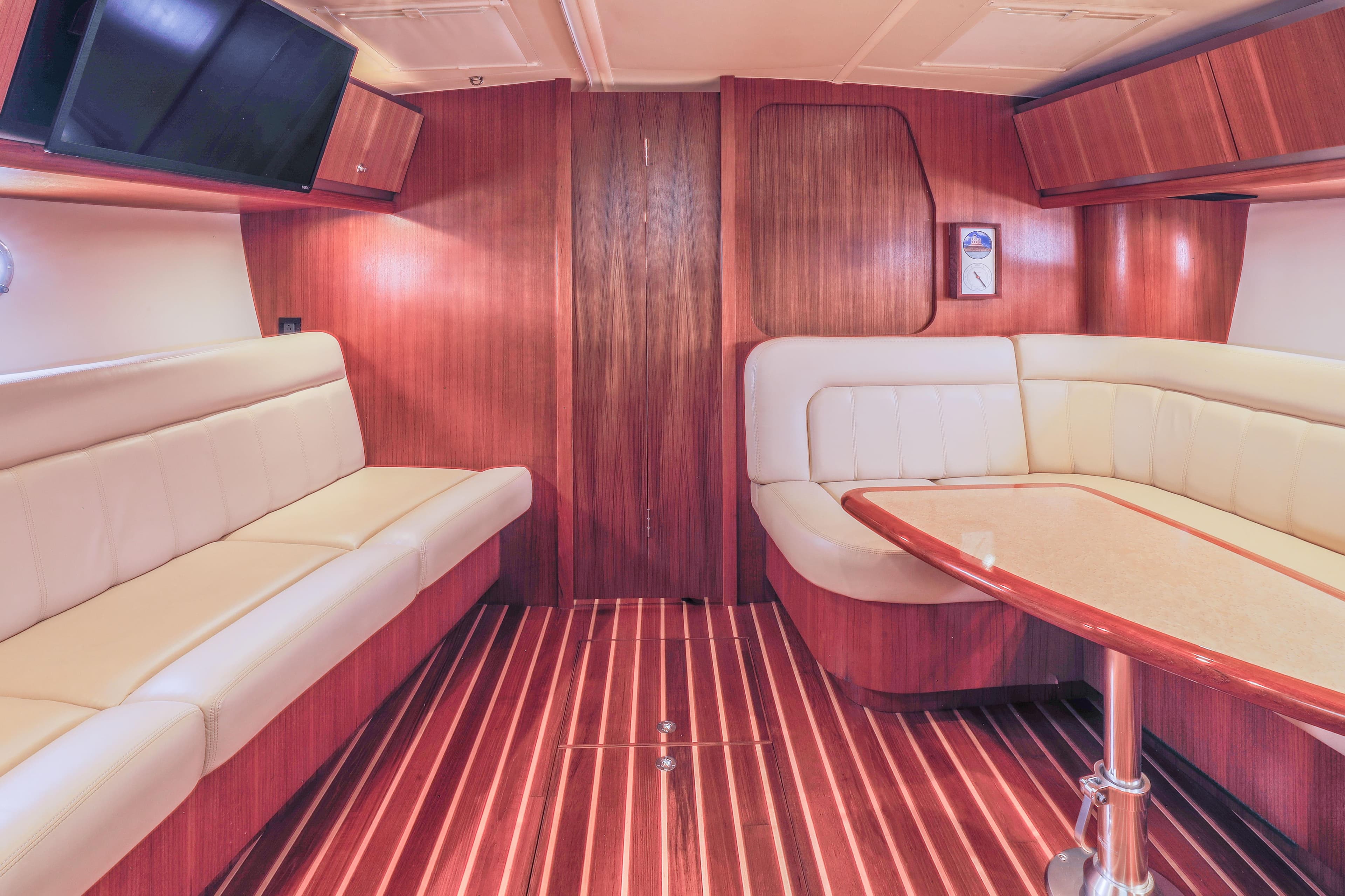 Luxurious interior of 2004 Tiara Yachts 3600 Sovran with elegant wood finish and plush seating.