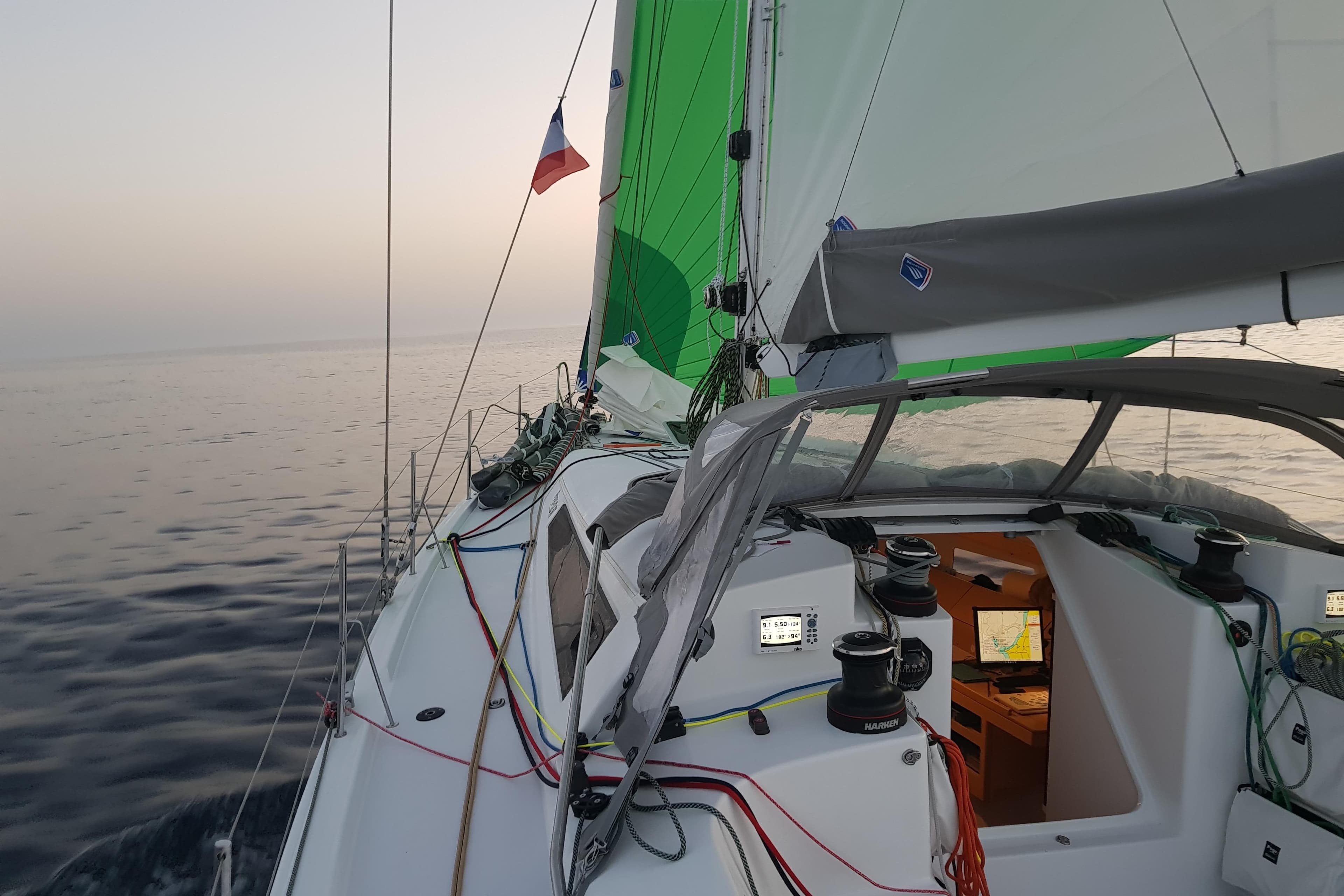 Sailing on a 2017 Pogo 1250 yacht with green sails and calm sea.
