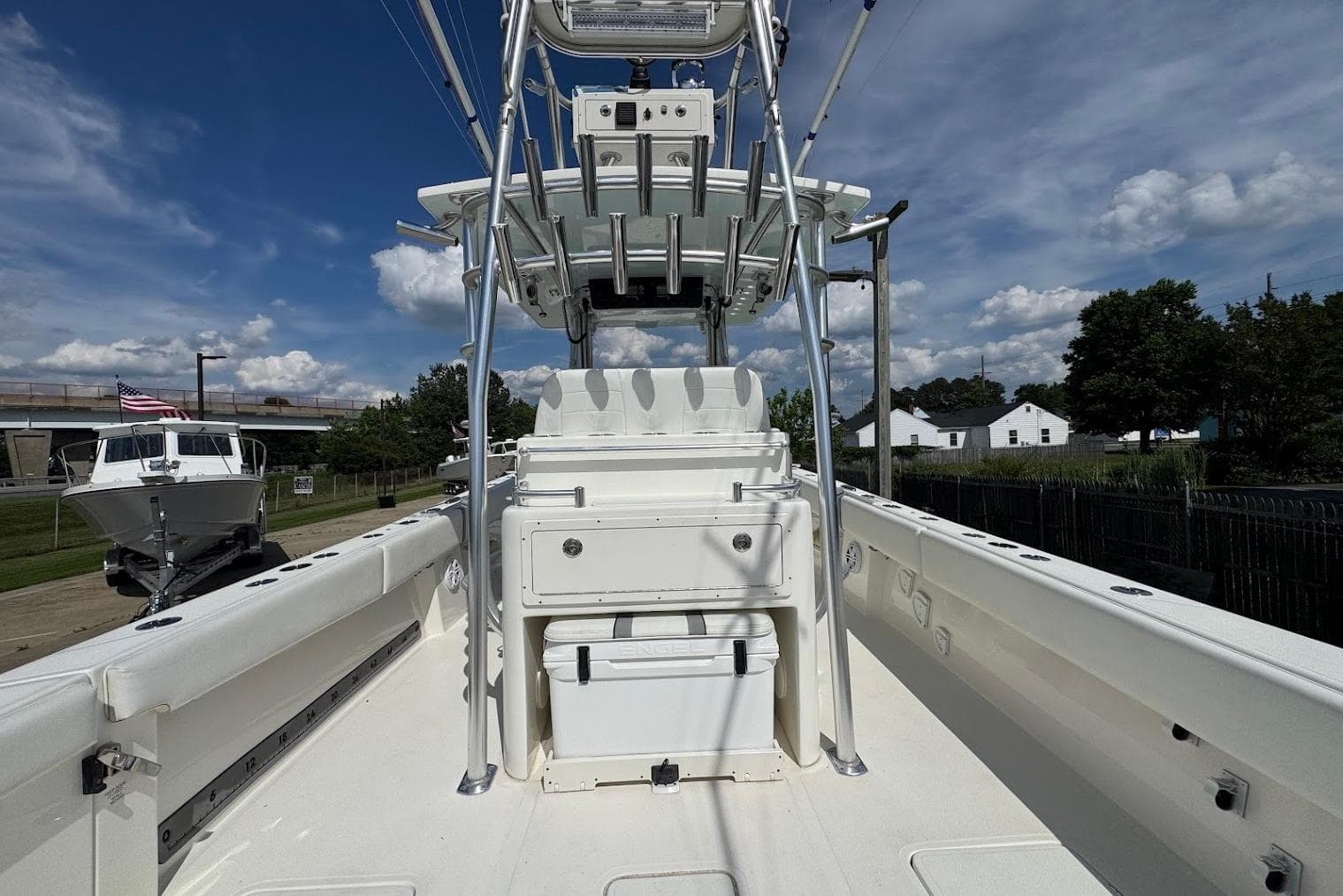 2021 Sealion 34 TE boat with center console and T-top under a clear blue sky.