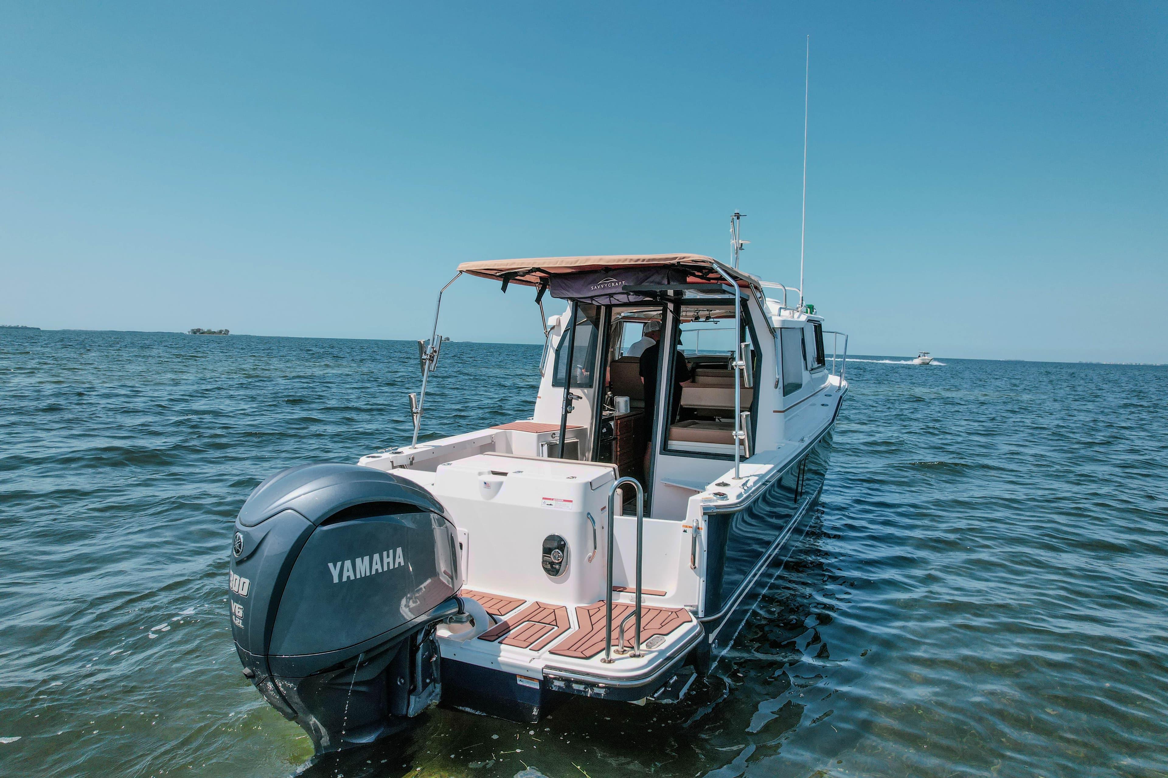 2024 FML R27 LE boat with Yamaha engine on open water.