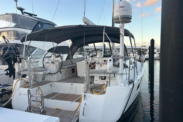 2016 Jeanneau 54 sailboat docked, featuring a spacious cockpit and sleek design.