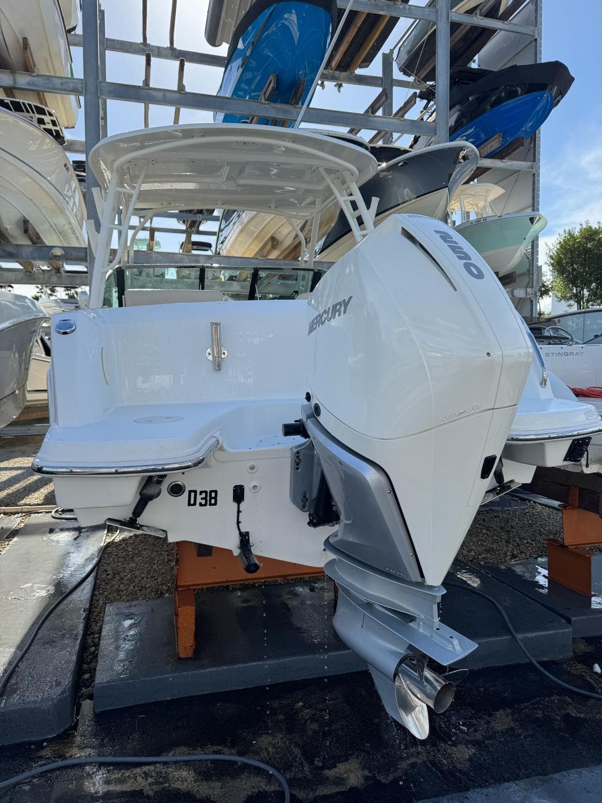 2020 Boston Whaler 230 Vantage boat with Mercury engine, docked in a marina.