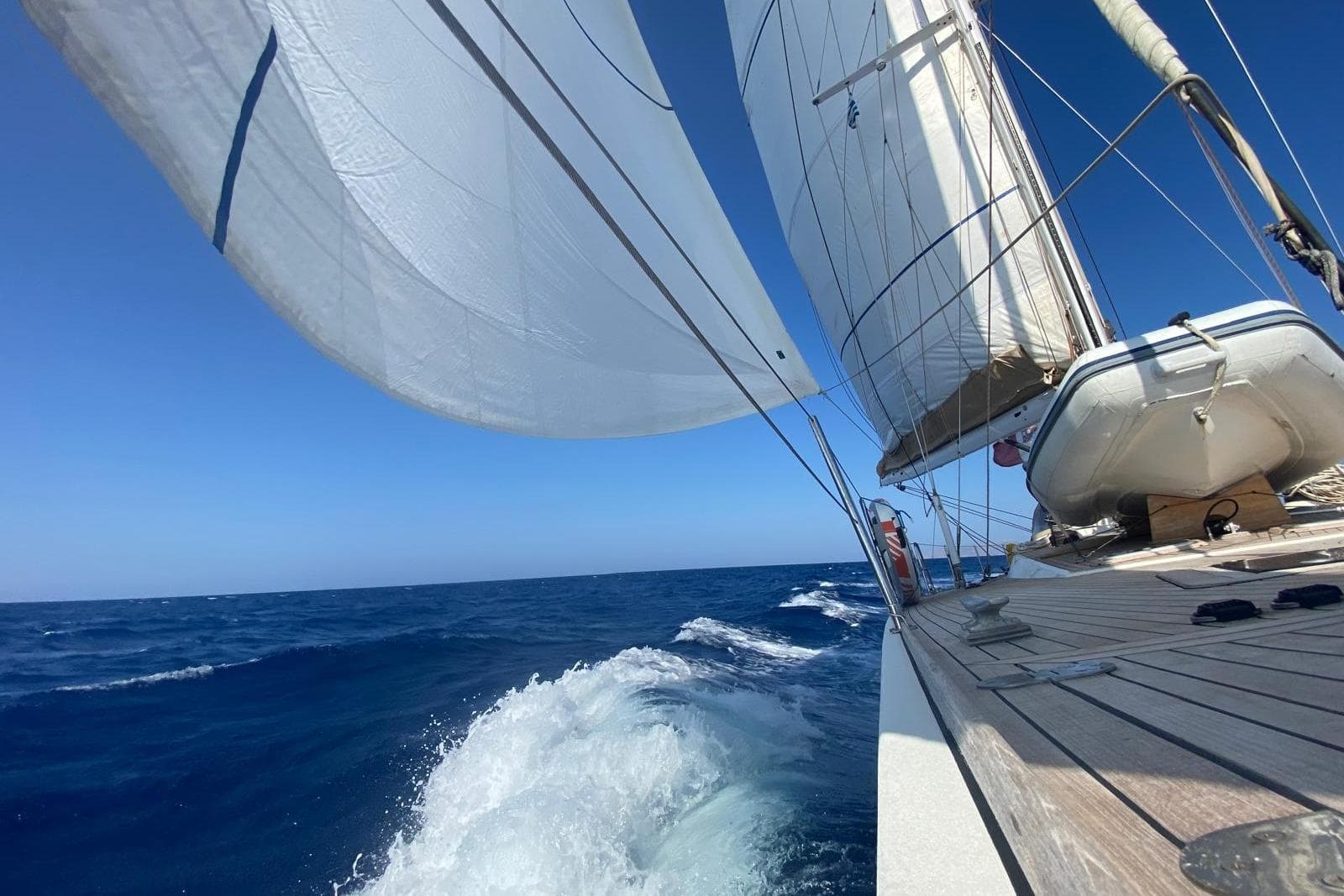 Sailing yacht De Cesari Vallicelli 72, 1991, gliding through ocean waves under clear blue skies.