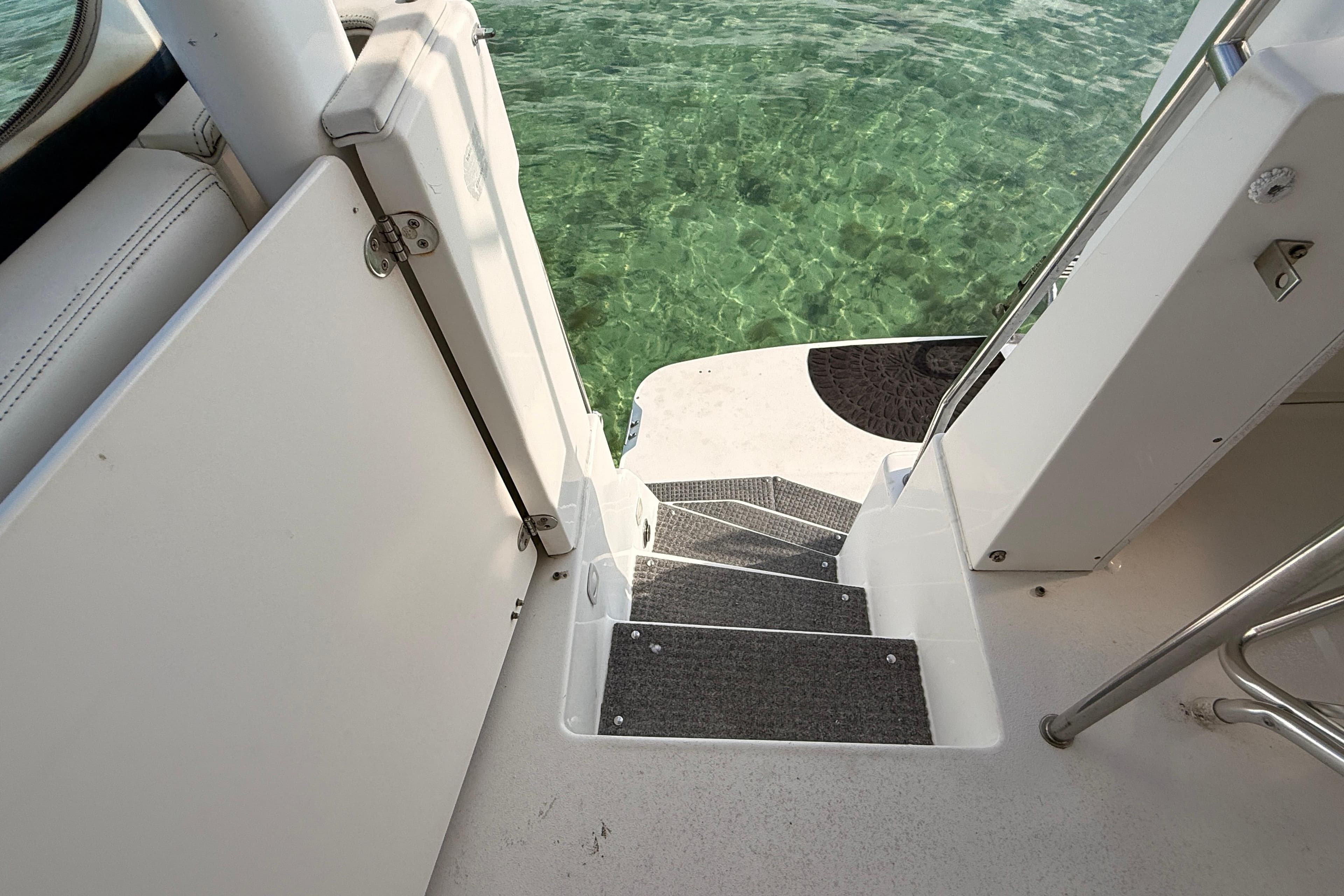 Stairway on 1998 Silverton 40 Convertible yacht leading to clear water.