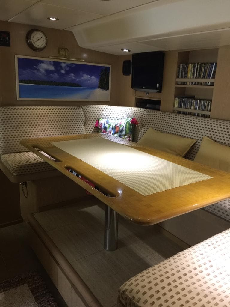 Luxurious 1991 Jongert 2900S yacht interior with elegant dining area and cozy seating.