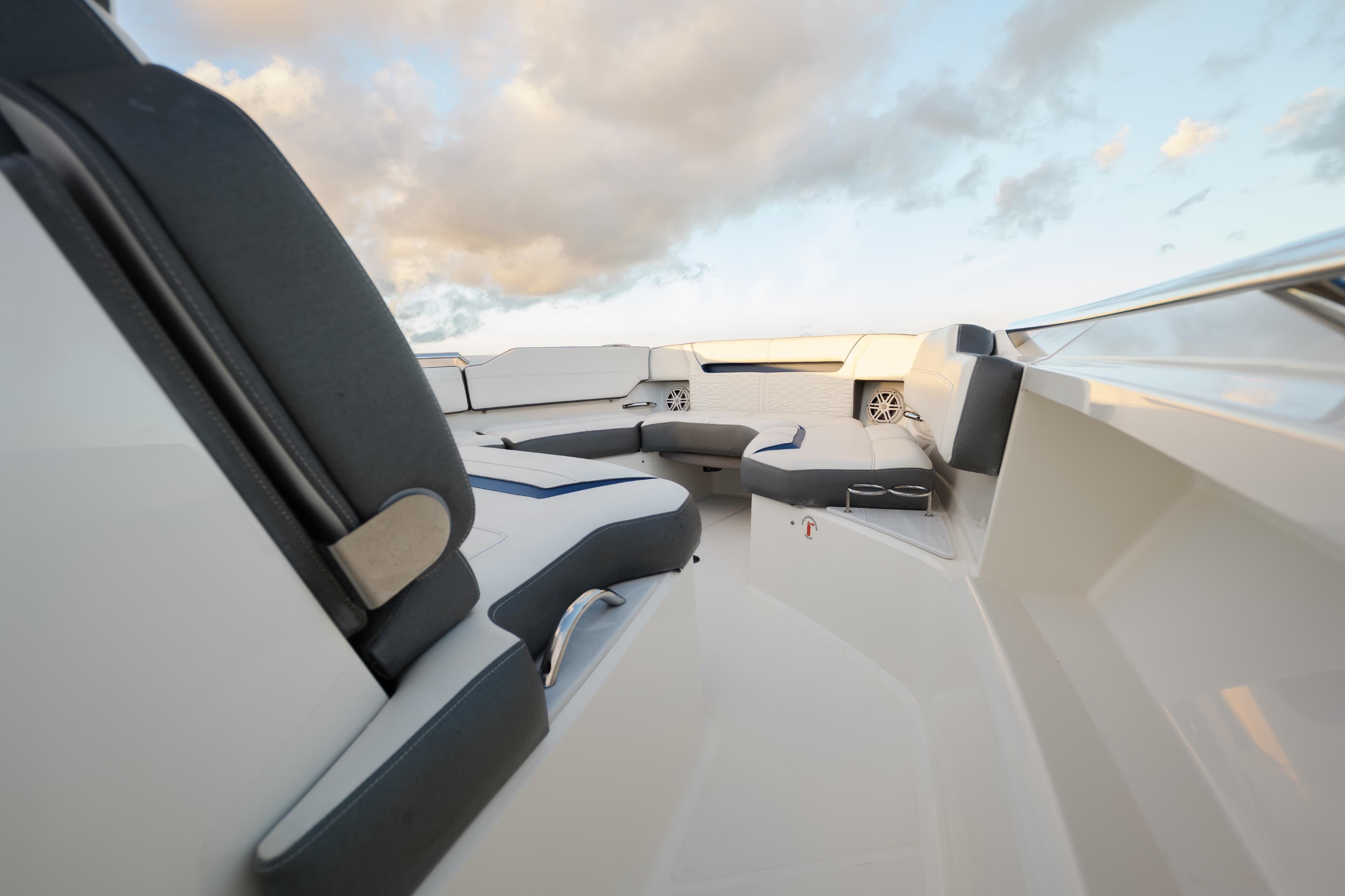 Luxurious seating area on 2020 Tiara Yachts 43 LS under a cloudy sky.