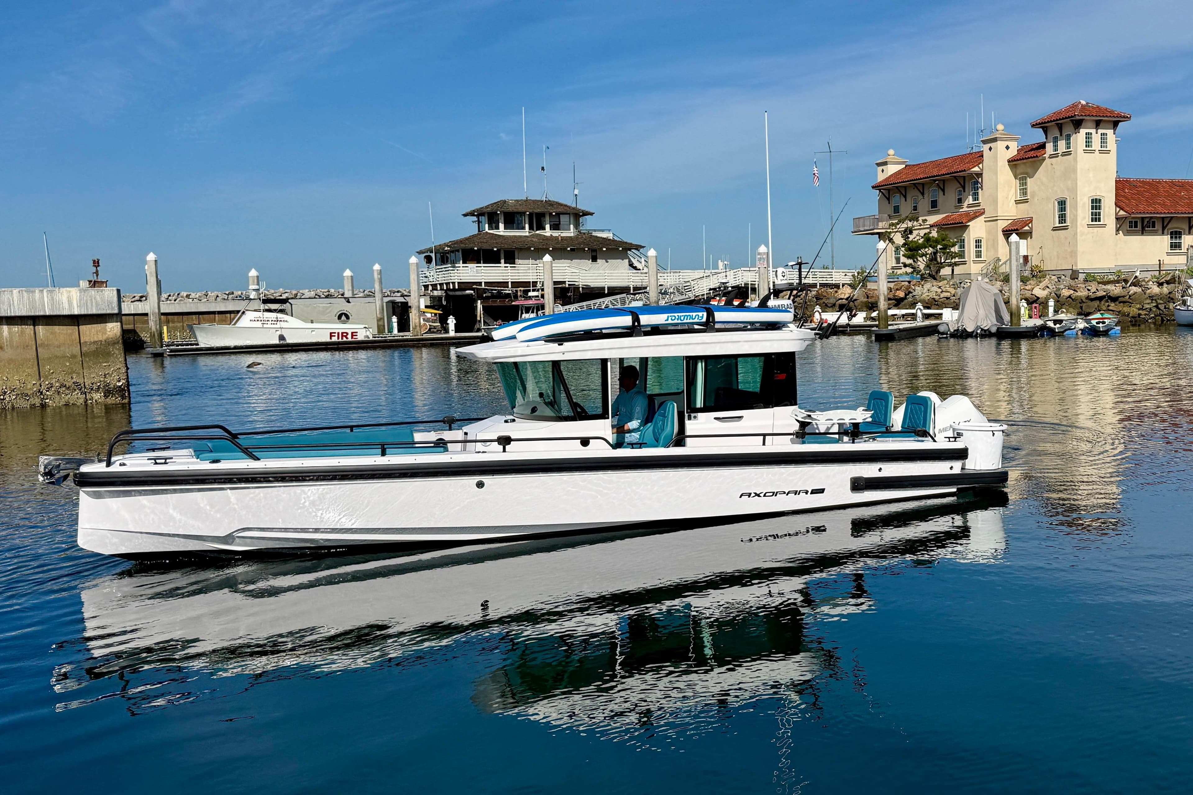 2021 Axopar Brabus 28 Cabin boat docked in a scenic marina setting.