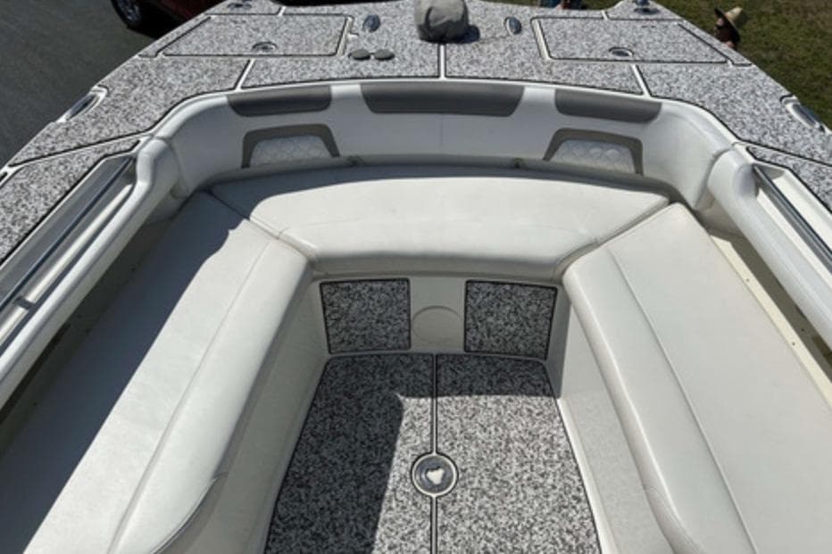 2018 World Cat 320 CC boat interior with cushioned seating and textured flooring.