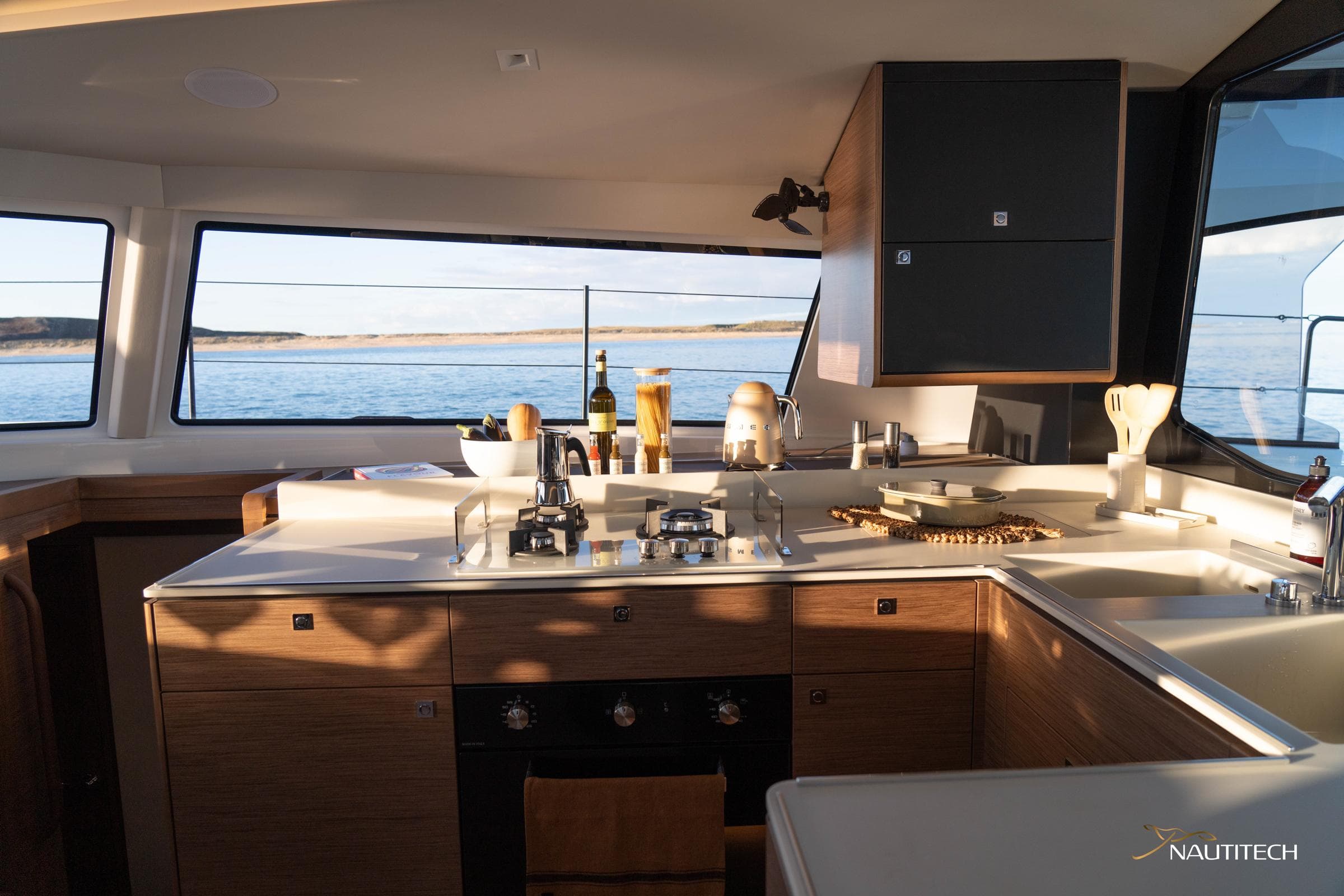 Modern kitchen interior of 2025 Nautitech 48 Open yacht with ocean view.