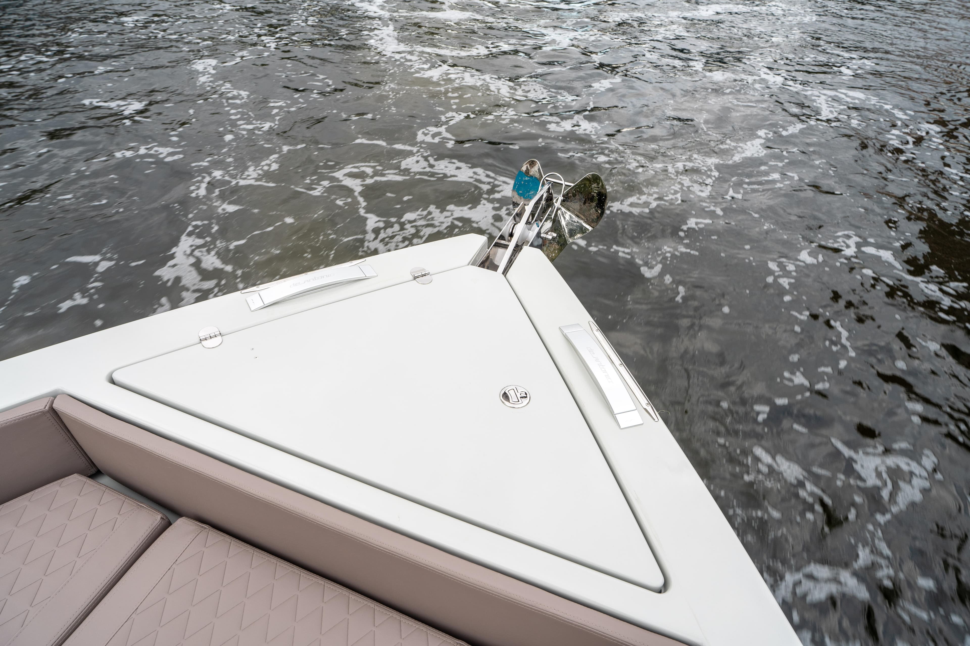 Bow of 2025 De Antonio Yachts D42 Open on water, featuring sleek design and anchor.