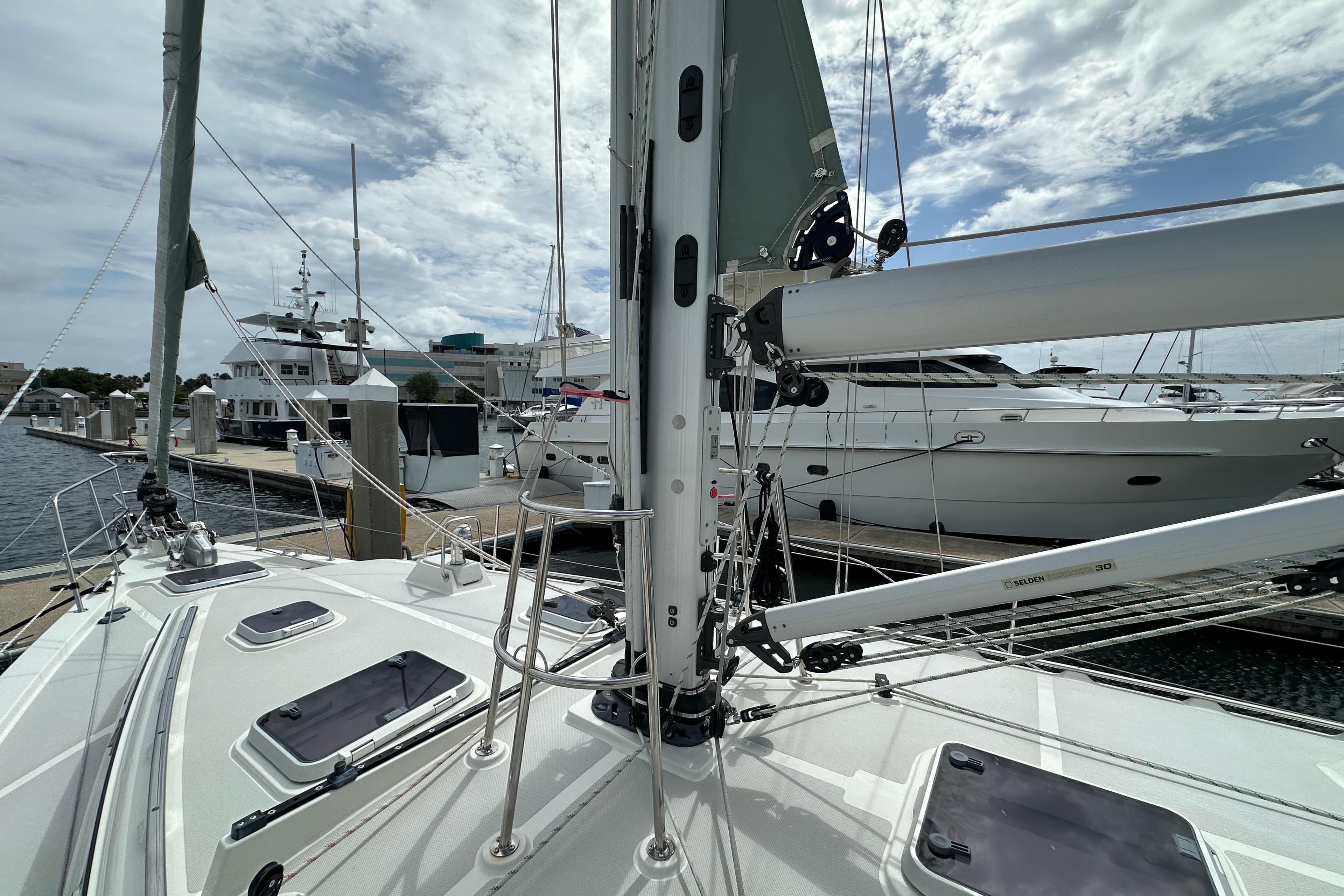 2023 Island Packet 439 sailboat docked at marina under cloudy sky.