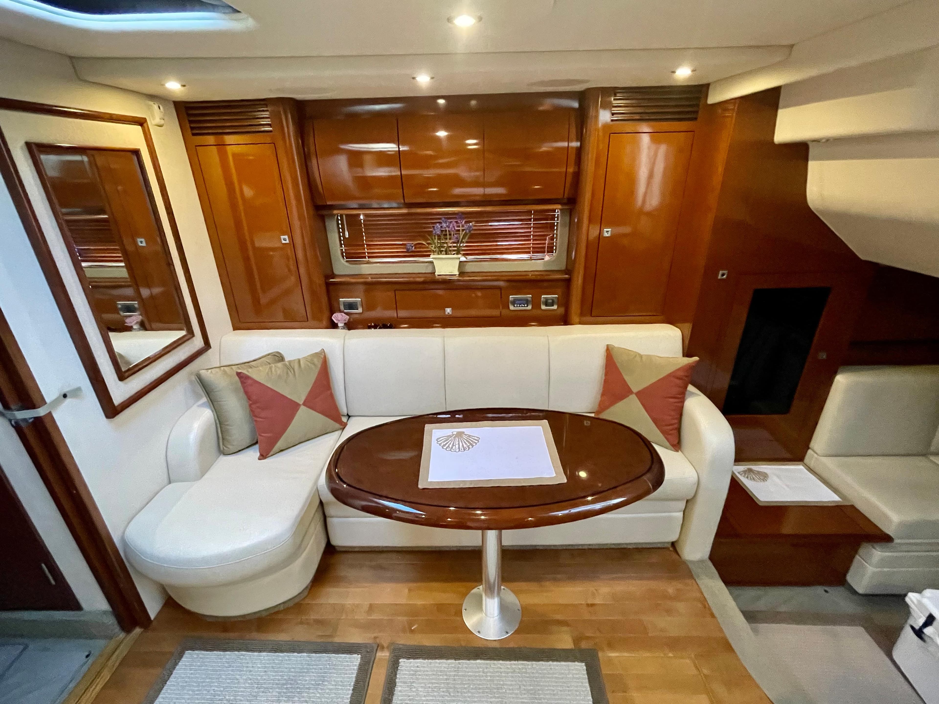 Luxurious interior of a 2008 Sea Ray 40 Sundancer yacht with elegant seating and wooden finishes.