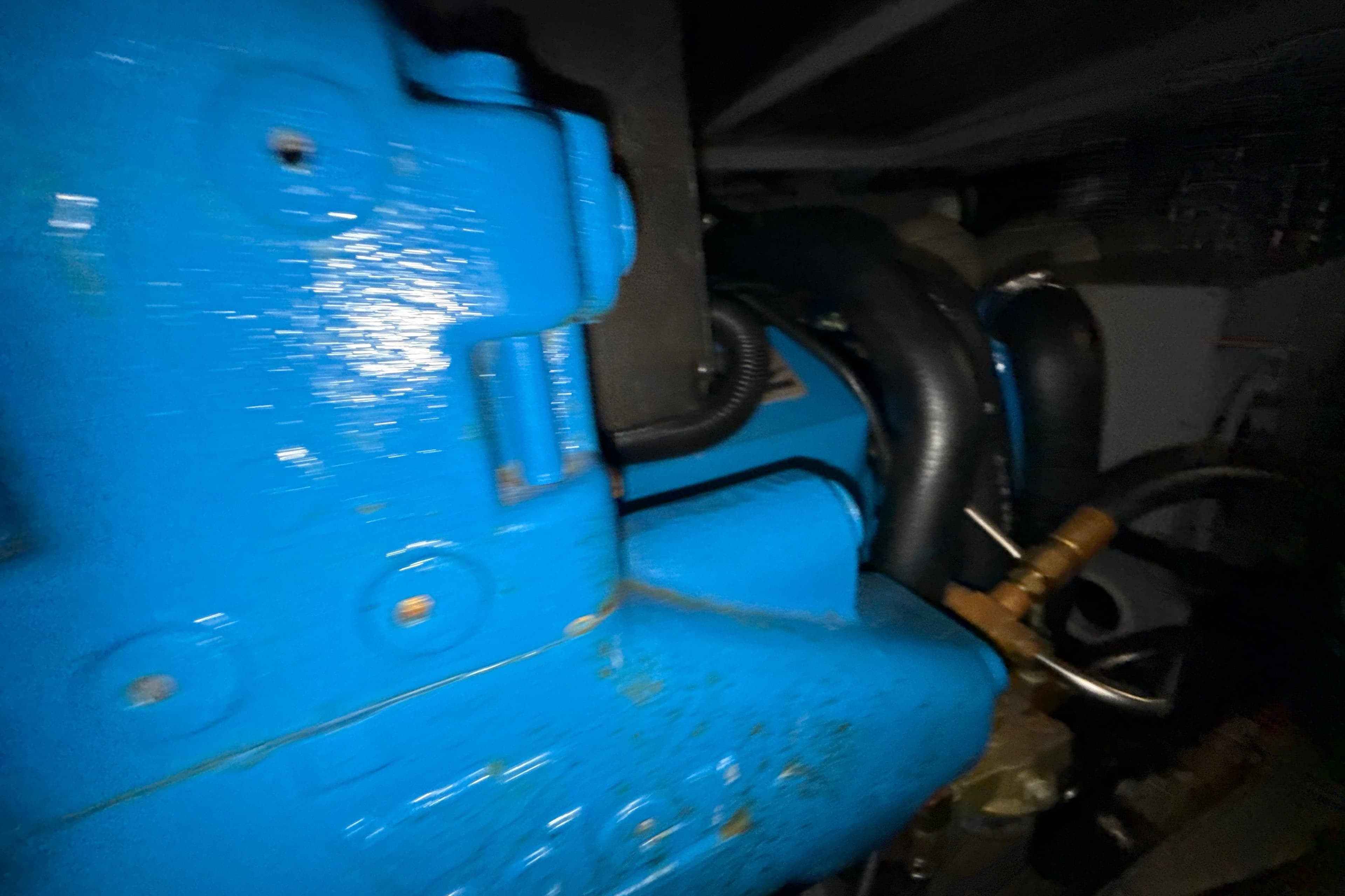 Engine compartment of a 1999 Silverton 422 Motor Yacht, featuring blue machinery components.
