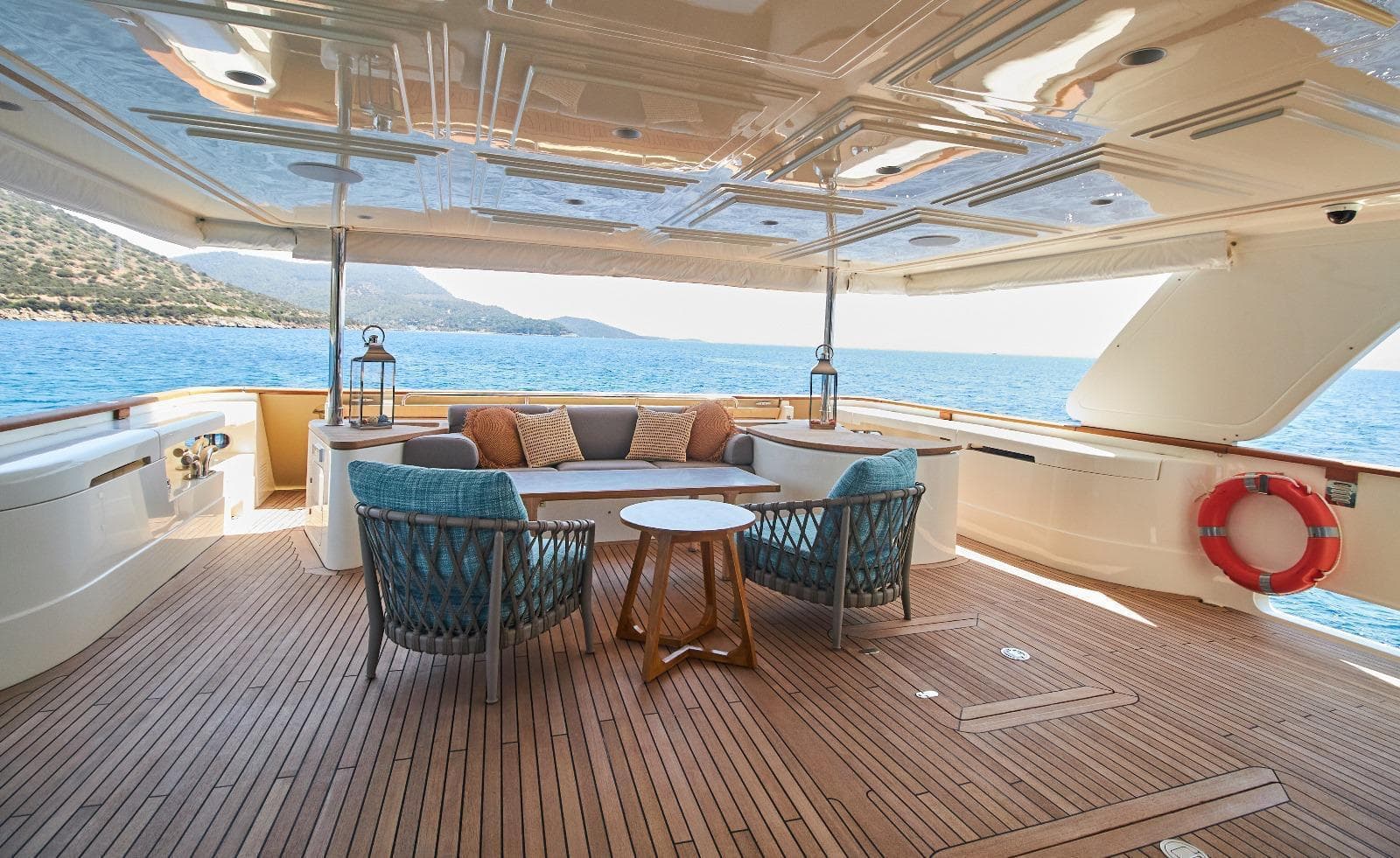 Luxurious Custom Line Navetta 33 yacht deck with seating, ocean view, and elegant decor.