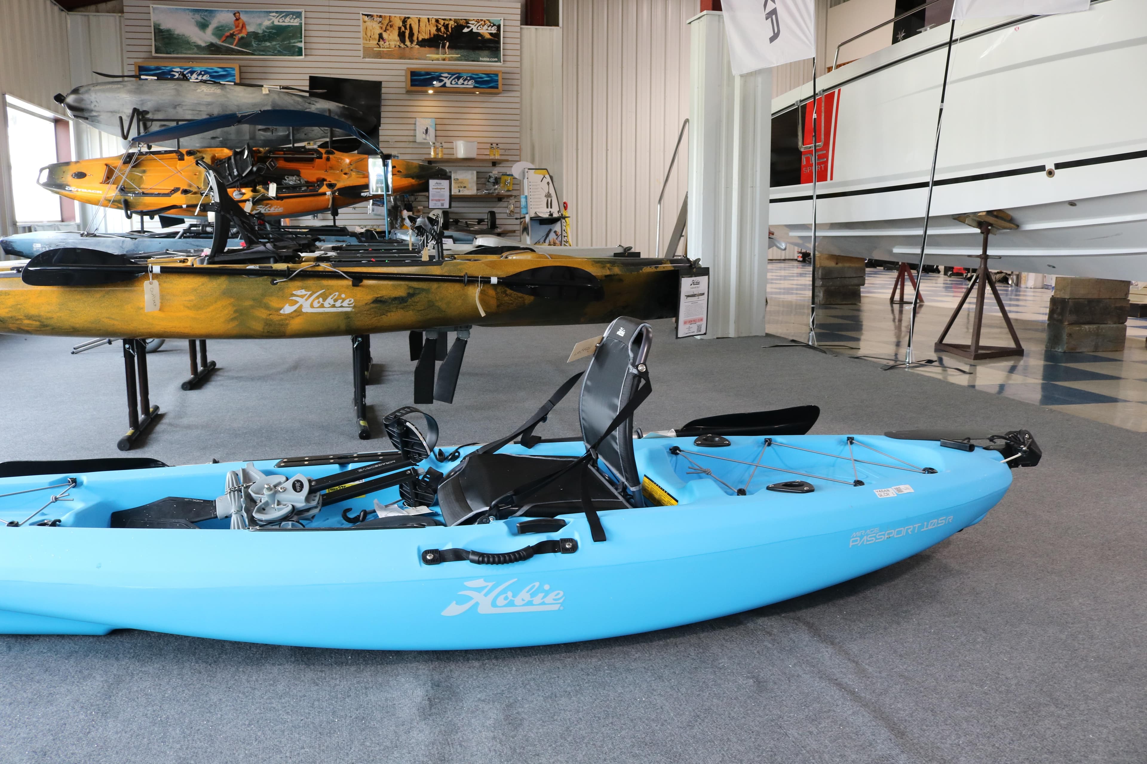 2024 Hobie Mirage Passport 10.5 R kayak displayed in a showroom setting.