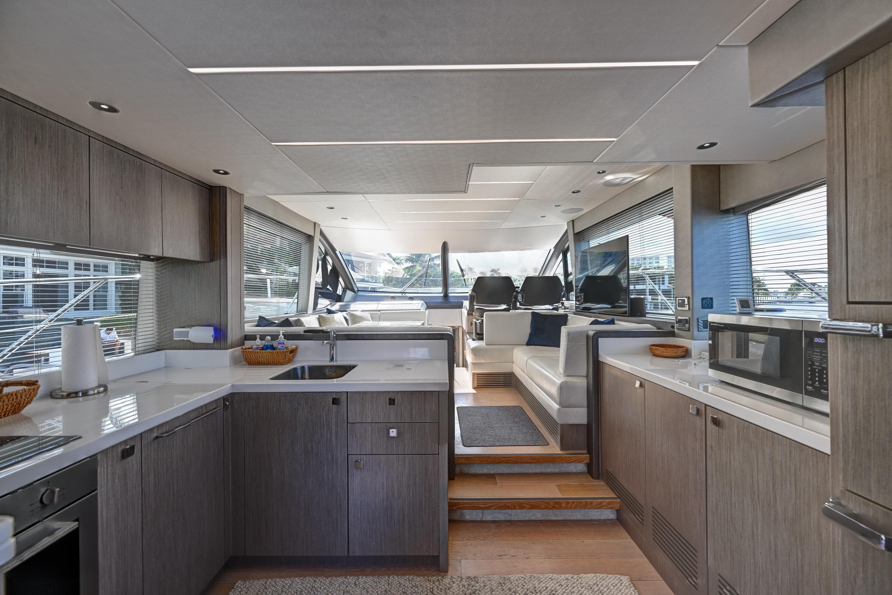 Luxurious interior of 2020 Sunseeker Manhattan 52 yacht with modern kitchen and seating area.