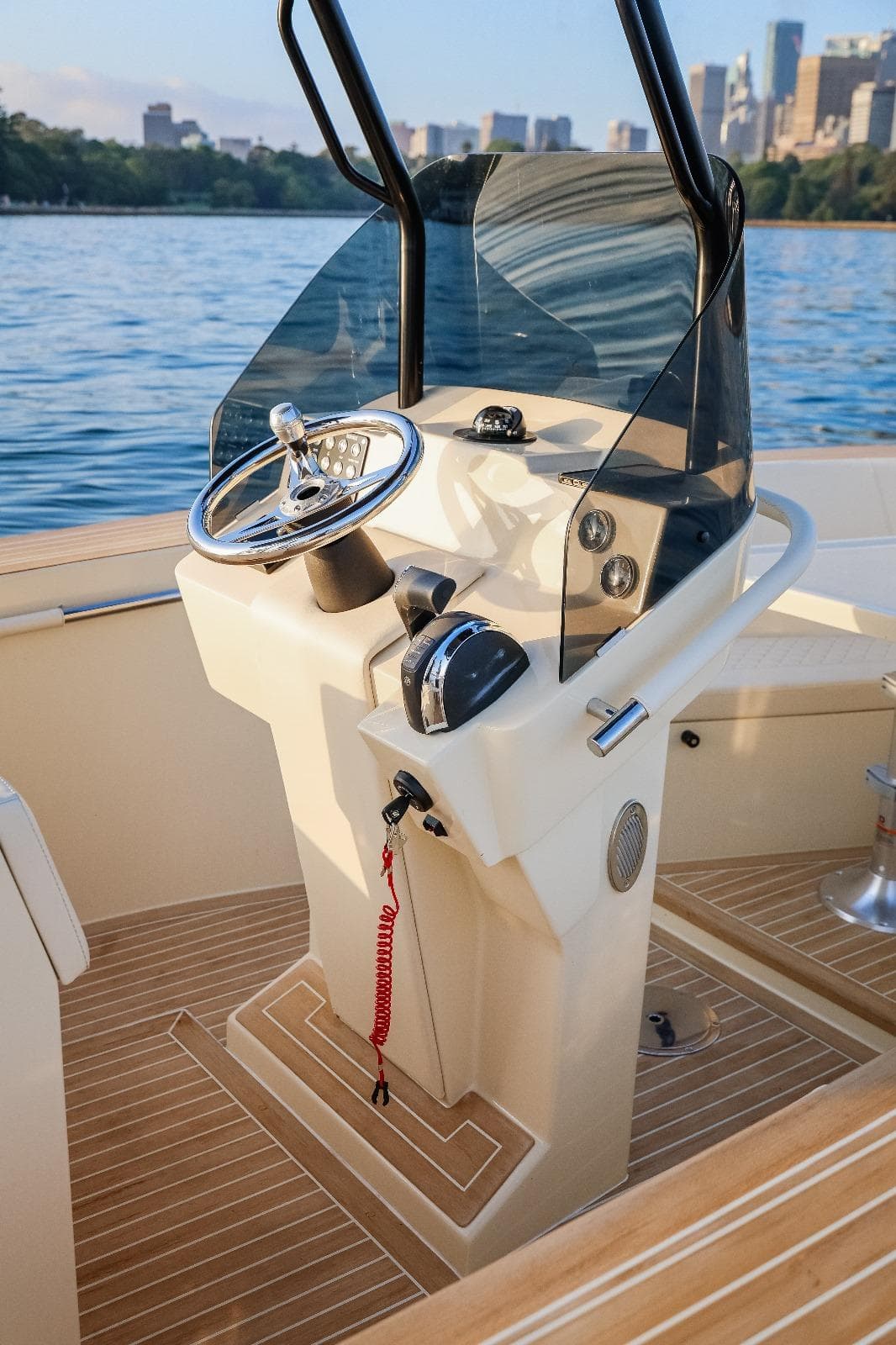 2025 AlCustom Levanzo 25 boat helm with steering wheel and controls, on calm water.