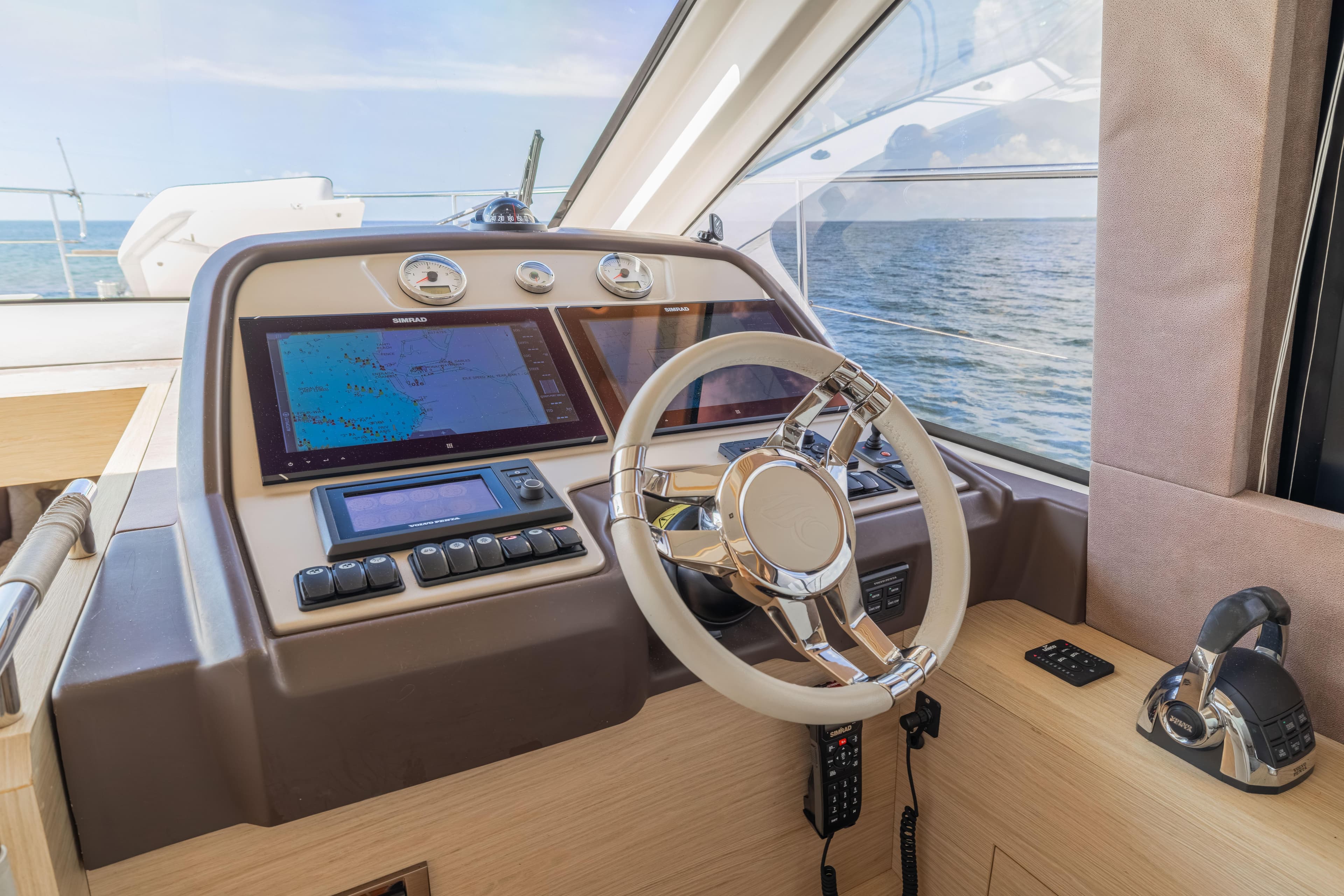 Cockpit of 2017 Monte Carlo Yachts MC5 with navigation system and steering wheel.