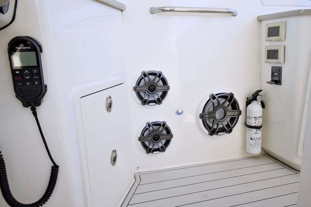 2019 Boston Whaler 350 Realm interior with speakers, fire extinguisher, and control panel.
