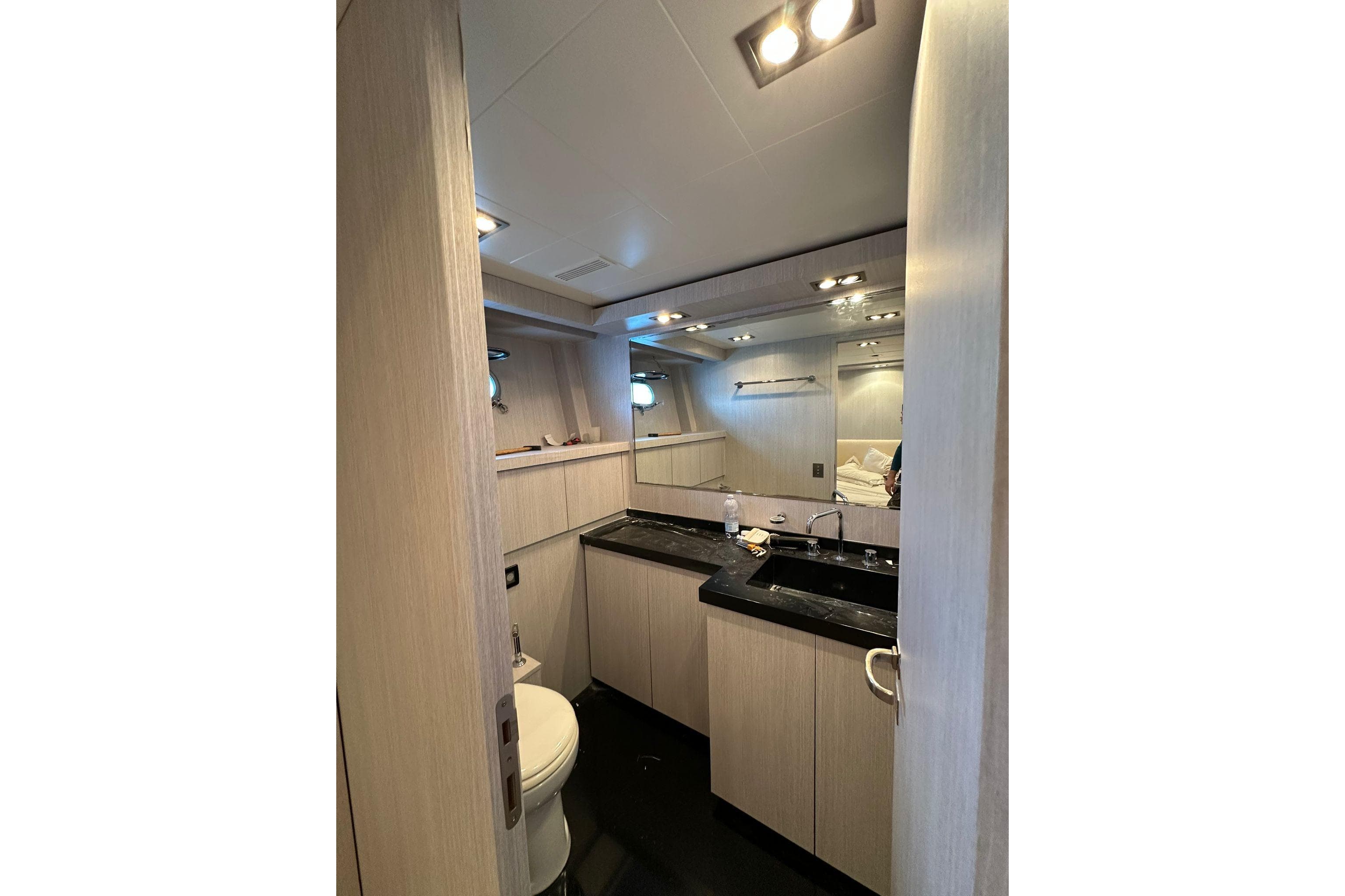 Luxurious bathroom interior of 2006 Mangusta 92 yacht with modern fixtures and lighting.
