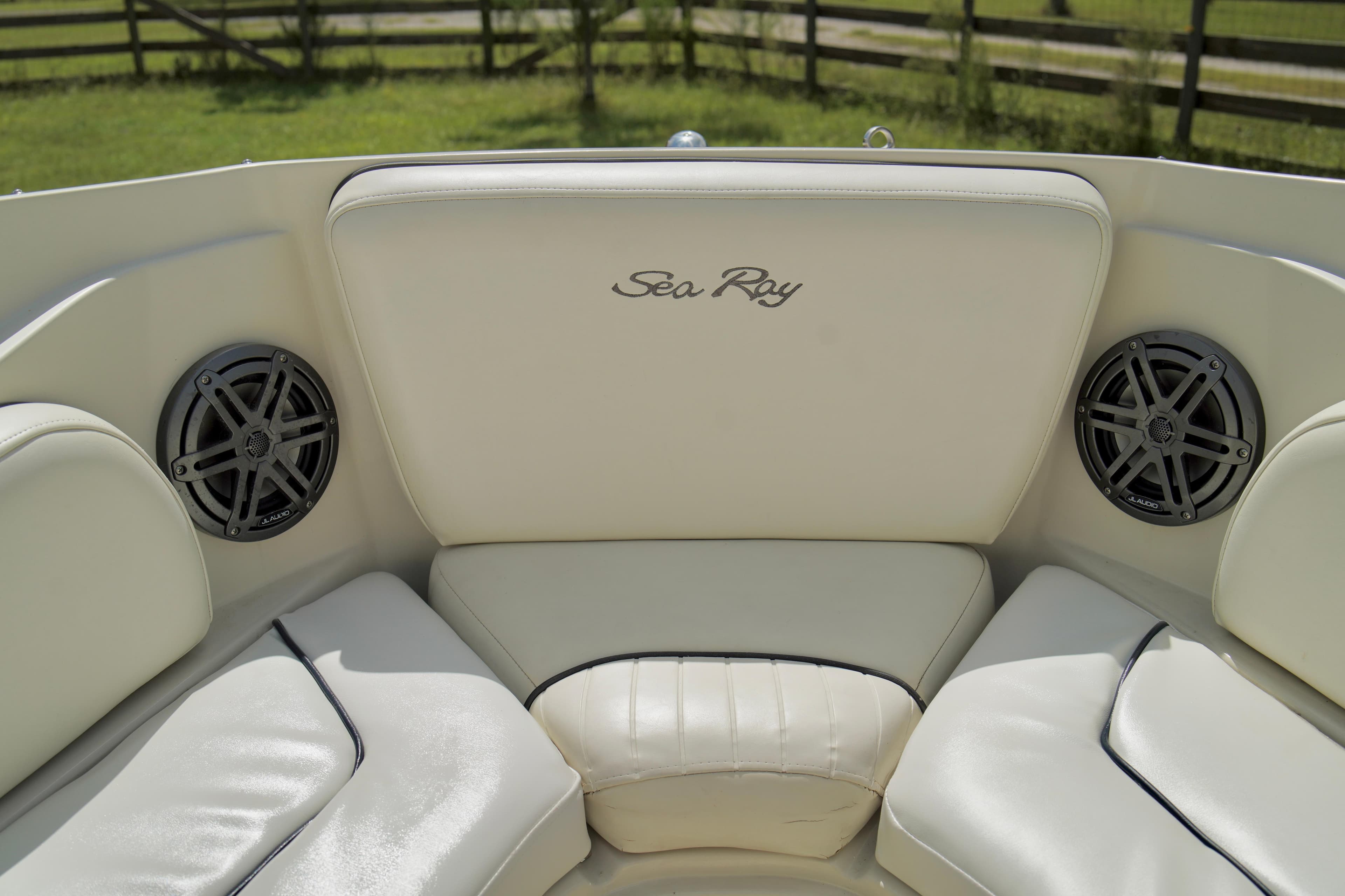 2008 Sea Ray 230 Select Fission boat interior with white leather seating and built-in speakers.