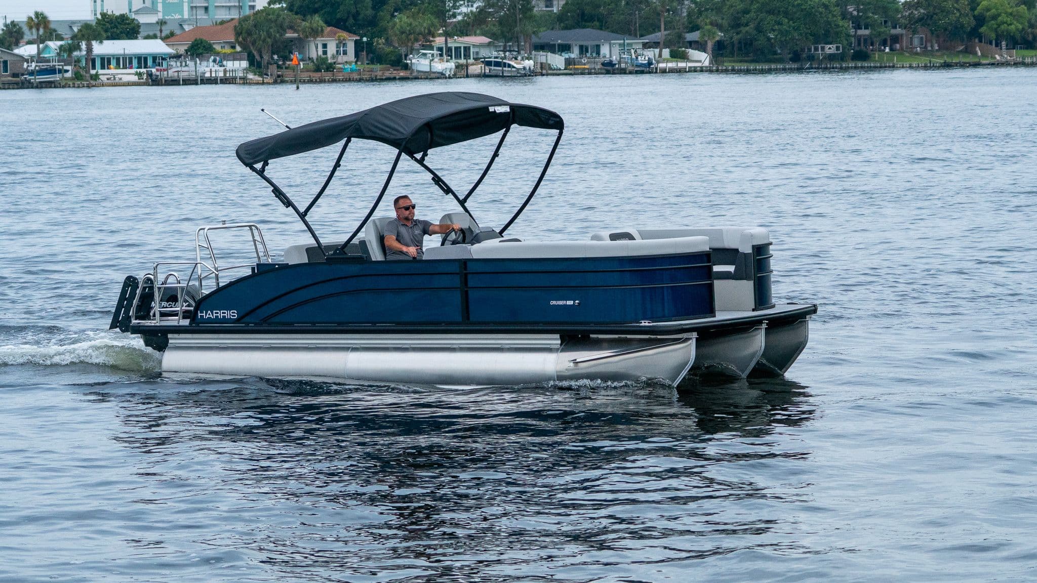 2026 Harris Cruiser 230 pontoon boat on the water.