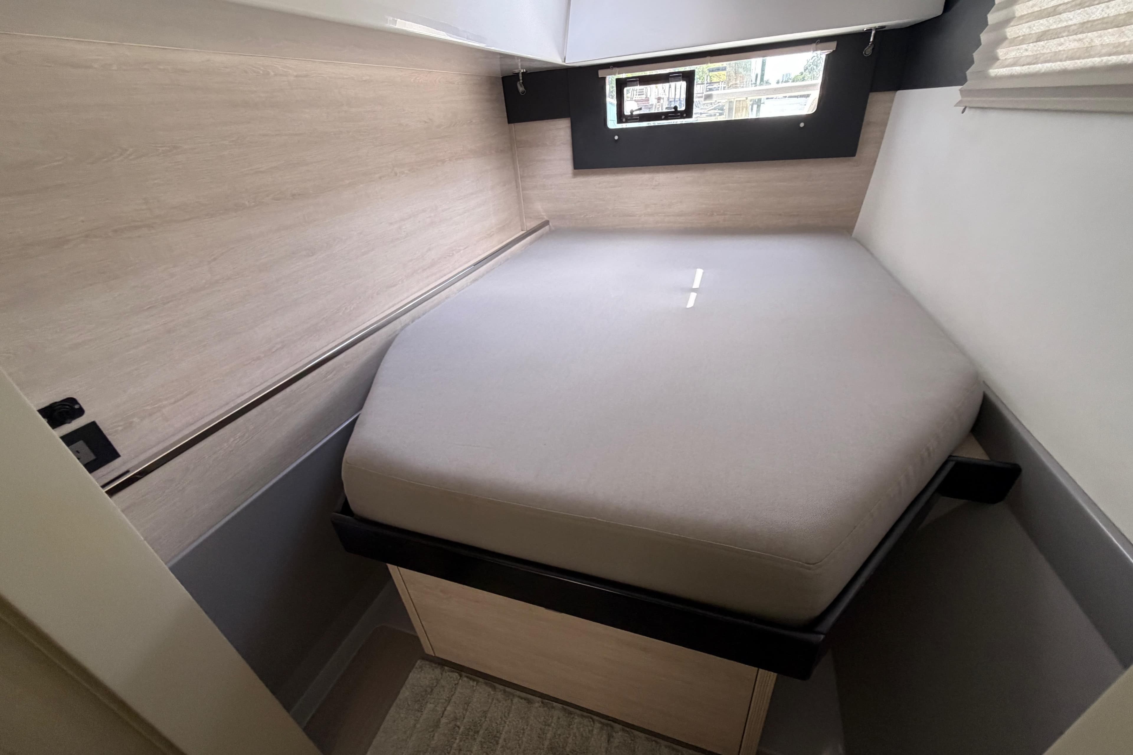 Compact cabin interior of a 2020 Leopard 40 catamaran with a cozy bed.