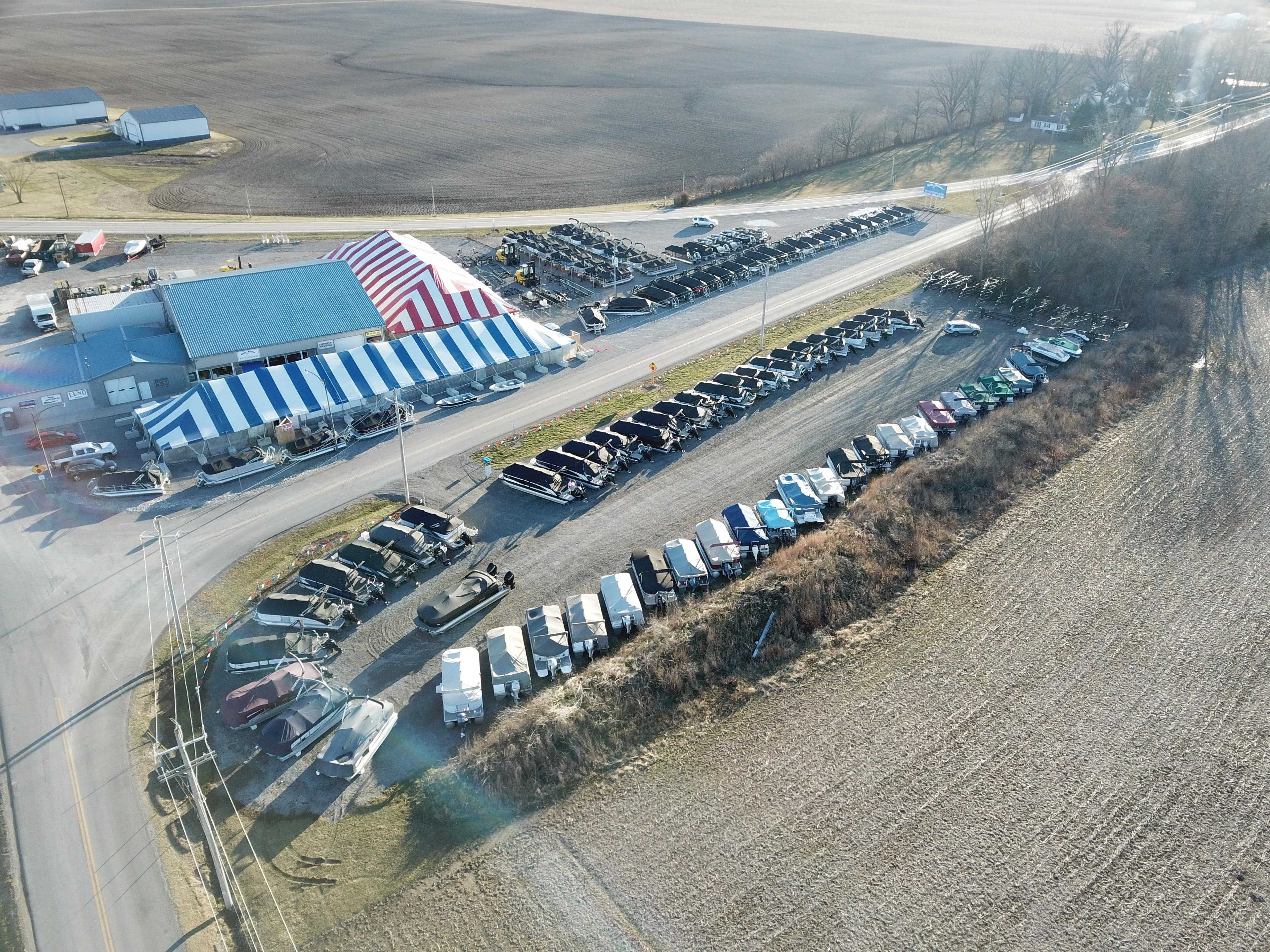 Aerial view of Bentley Pontoons dealership showcasing 2025 Legacy 223 Swingback models.
