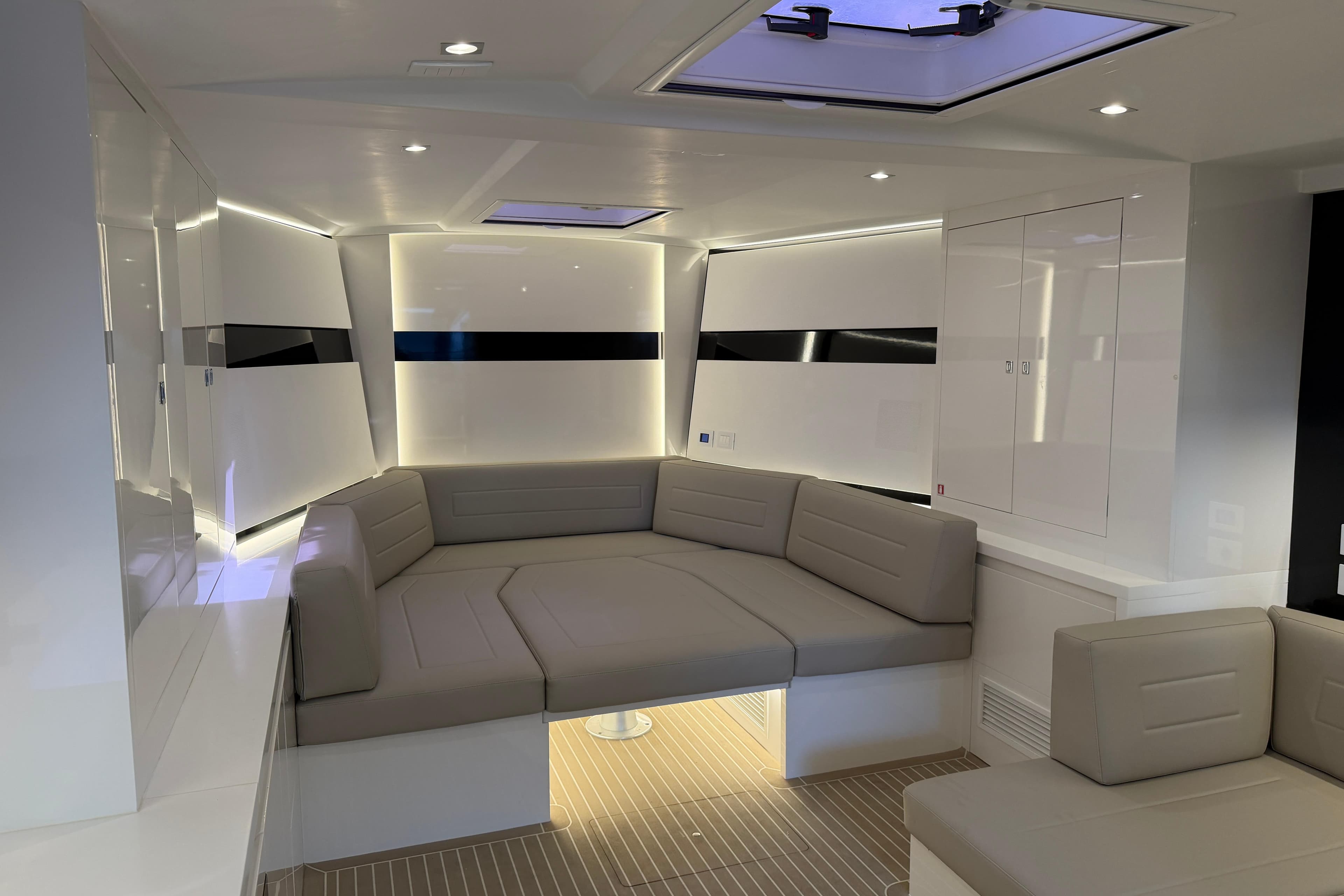 Luxurious interior of 2023 VanDutch 56 yacht with modern seating and ambient lighting.