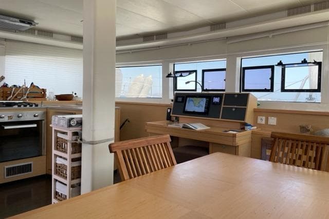 Interior of 2016 Lagoon 52 F yacht with navigation station and kitchen area.