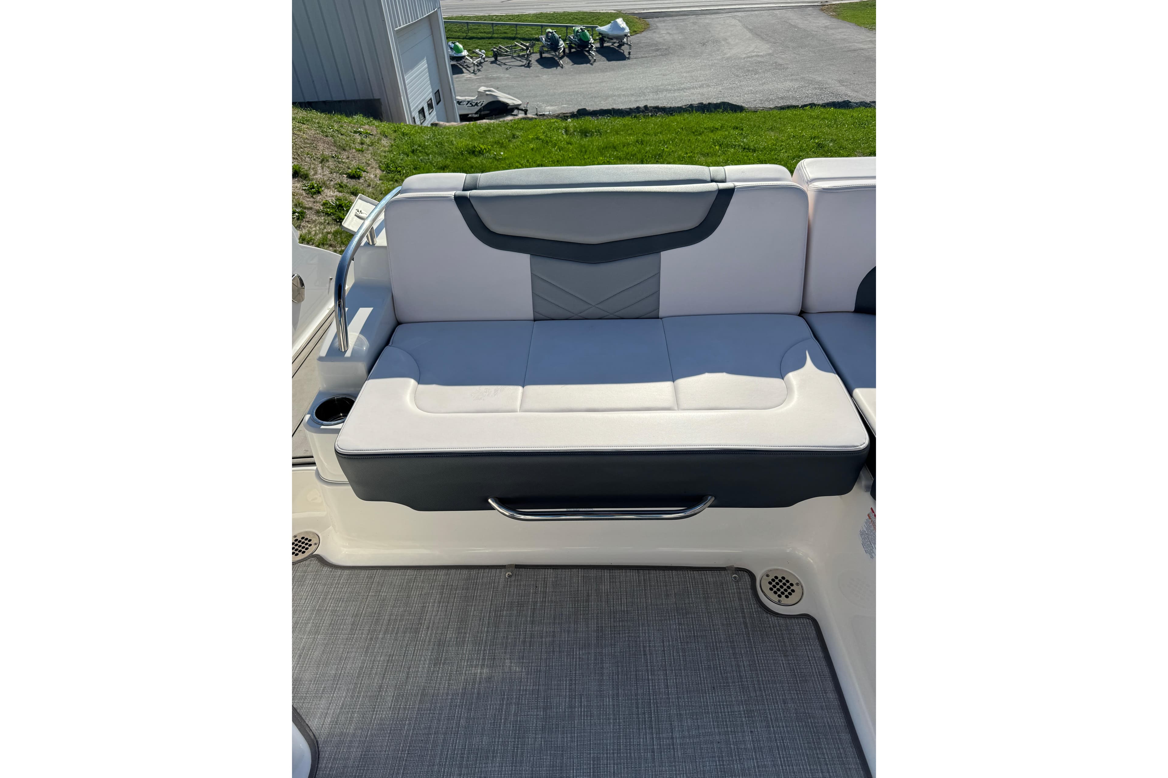 2019 Chaparral 297 SSX boat interior with cushioned seating and cup holder.