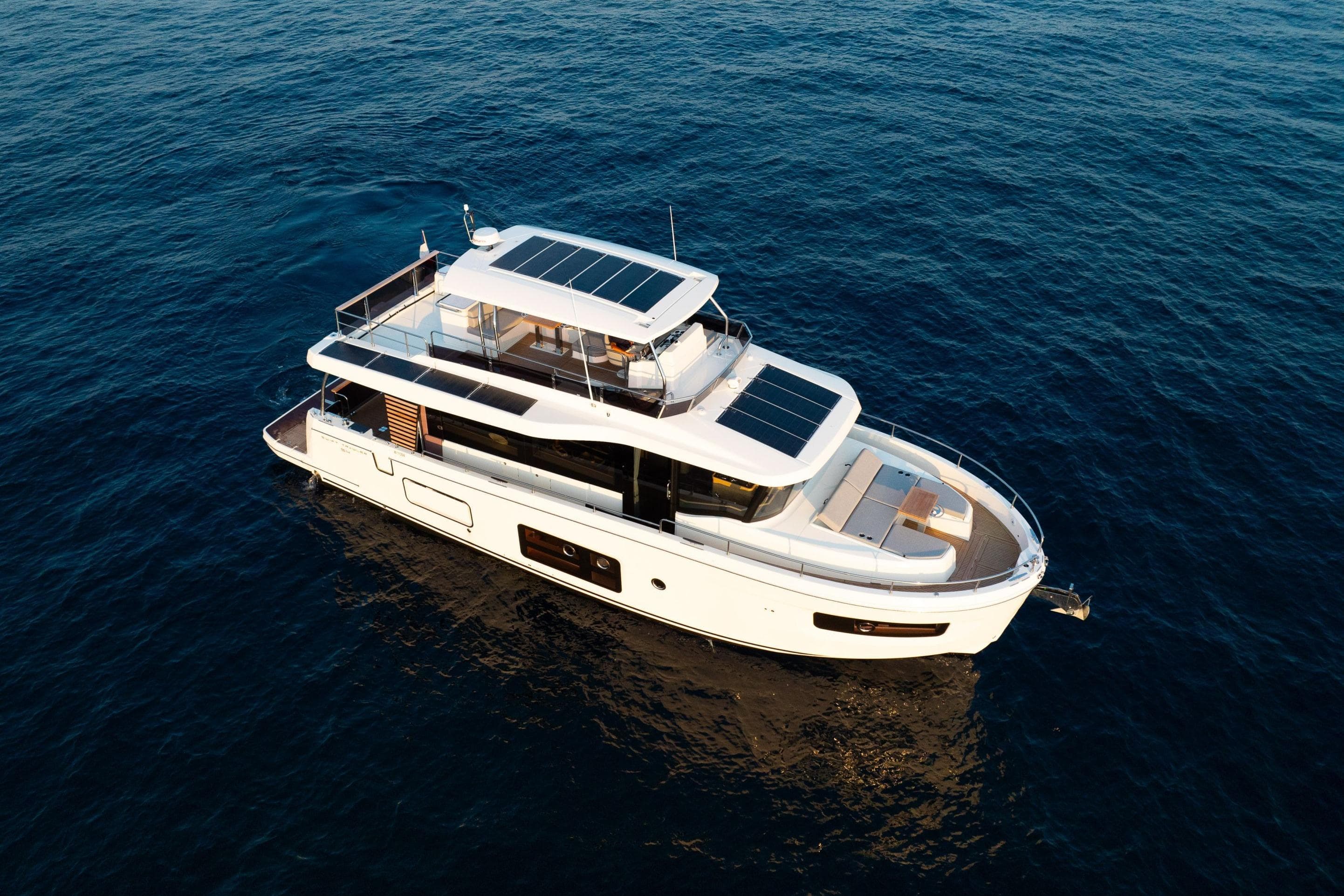 2026 Beneteau Swift Trawler 54 cruising on open sea, aerial view.