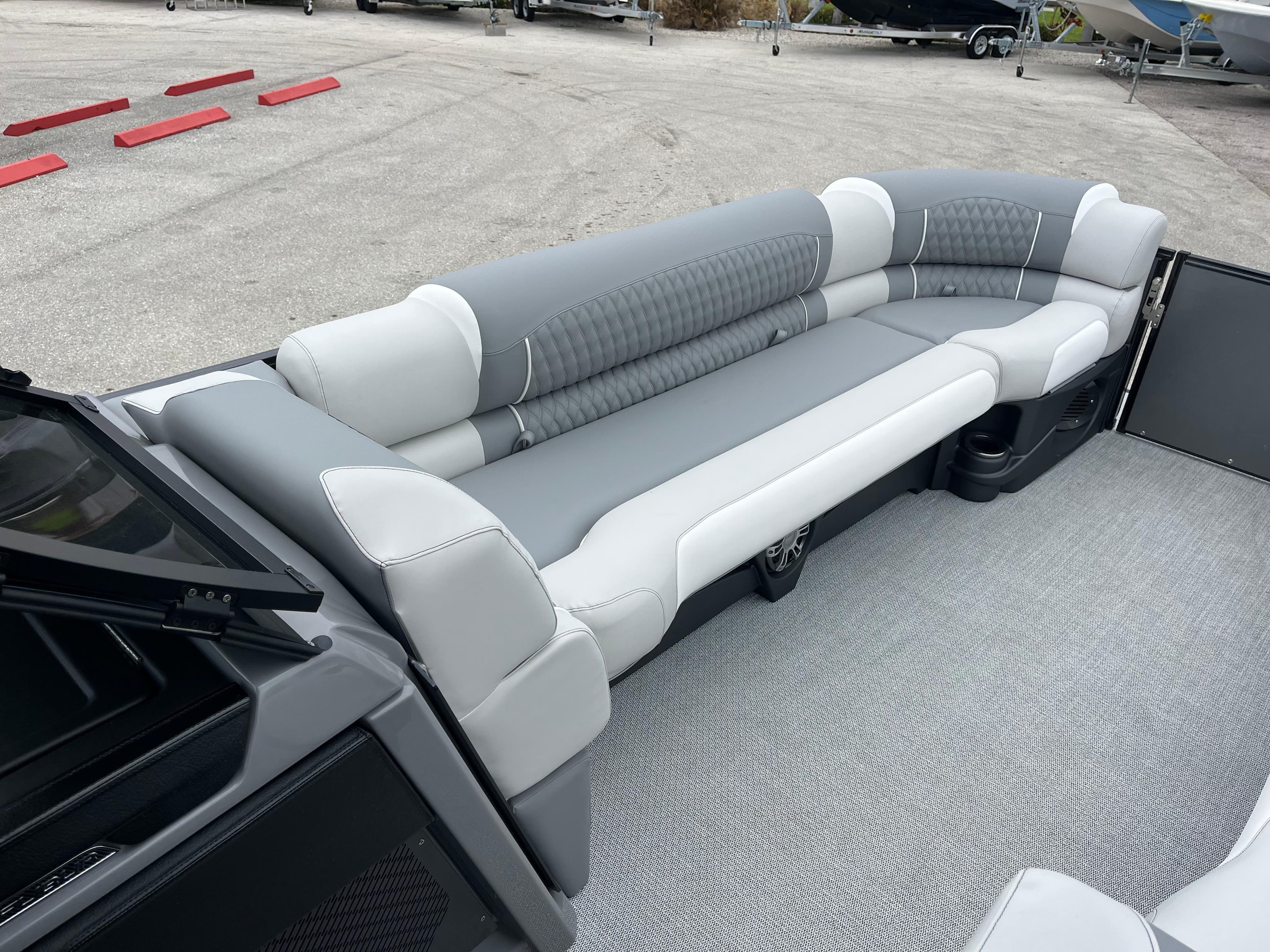 Luxurious seating on 2026 Avalon 2785 Excalibur LTD Windshield Quad Lounger boat.