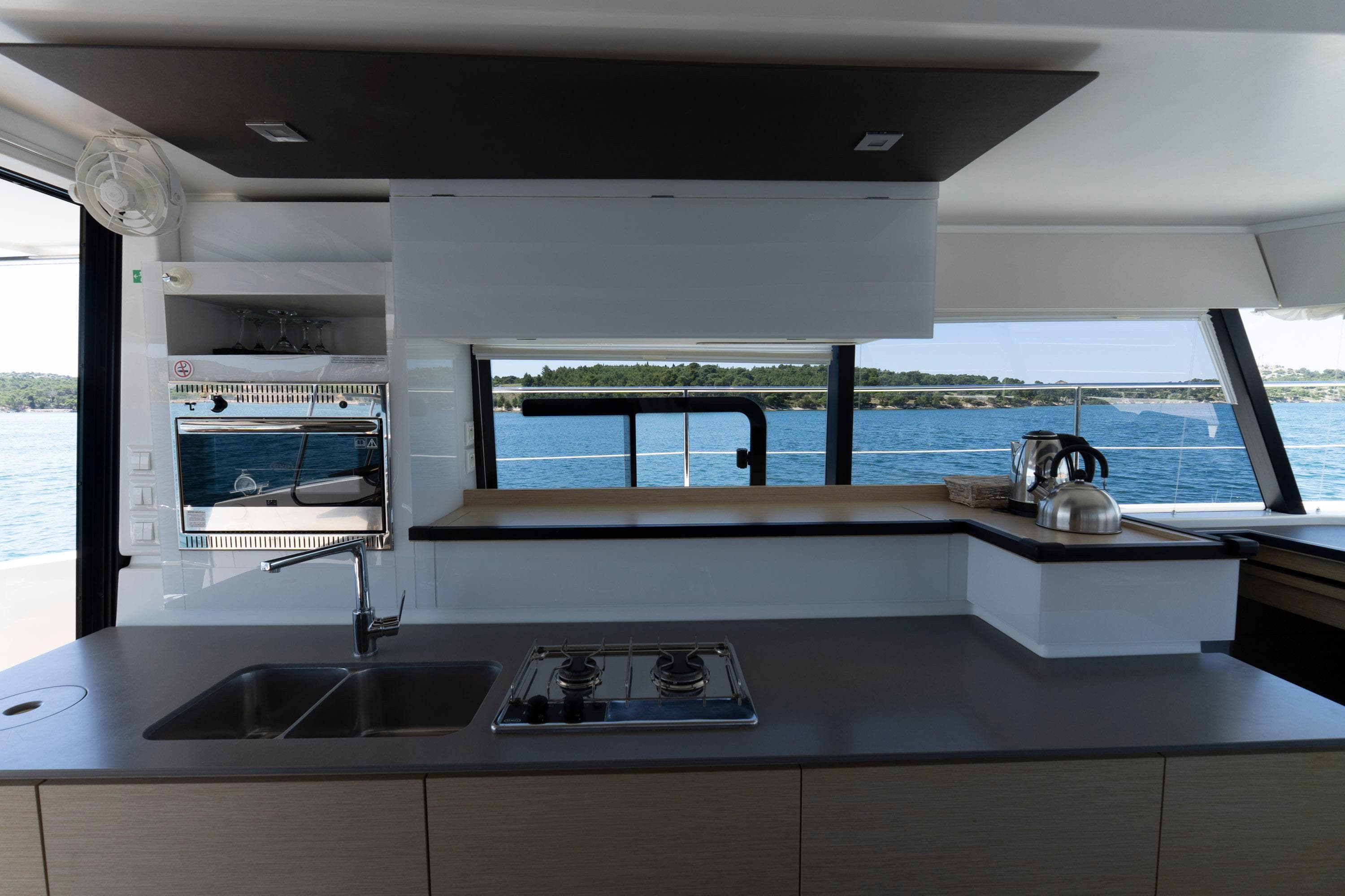 Modern kitchen interior on 2019 Fountaine Pajot MY 37 yacht with ocean view.