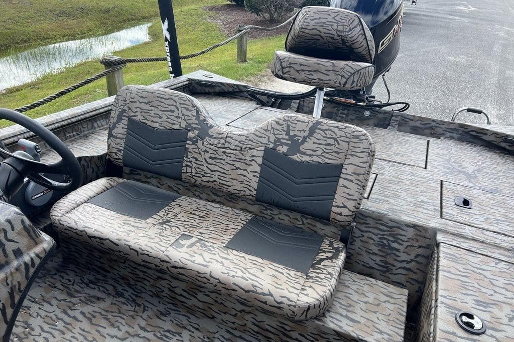2026 Xpress XP200 boat interior with camouflage seating and steering wheel.