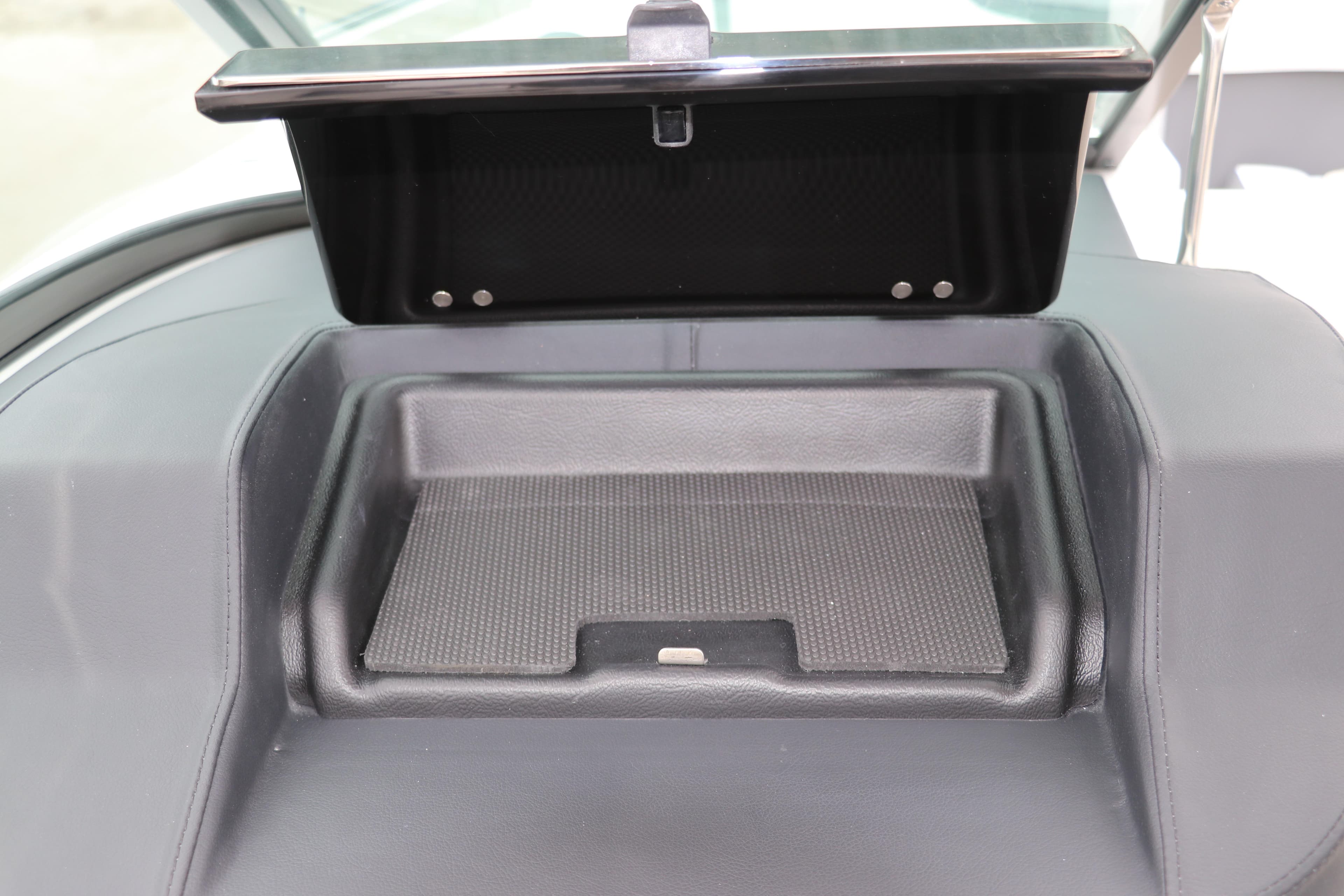 Storage compartment in 2026 Chaparral 270 OSX boat dashboard.