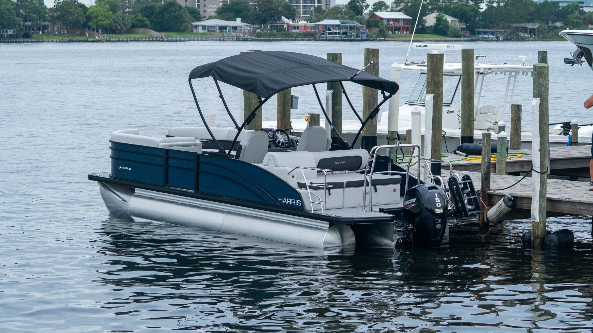 2026 Harris Cruiser 230 pontoon boat docked.