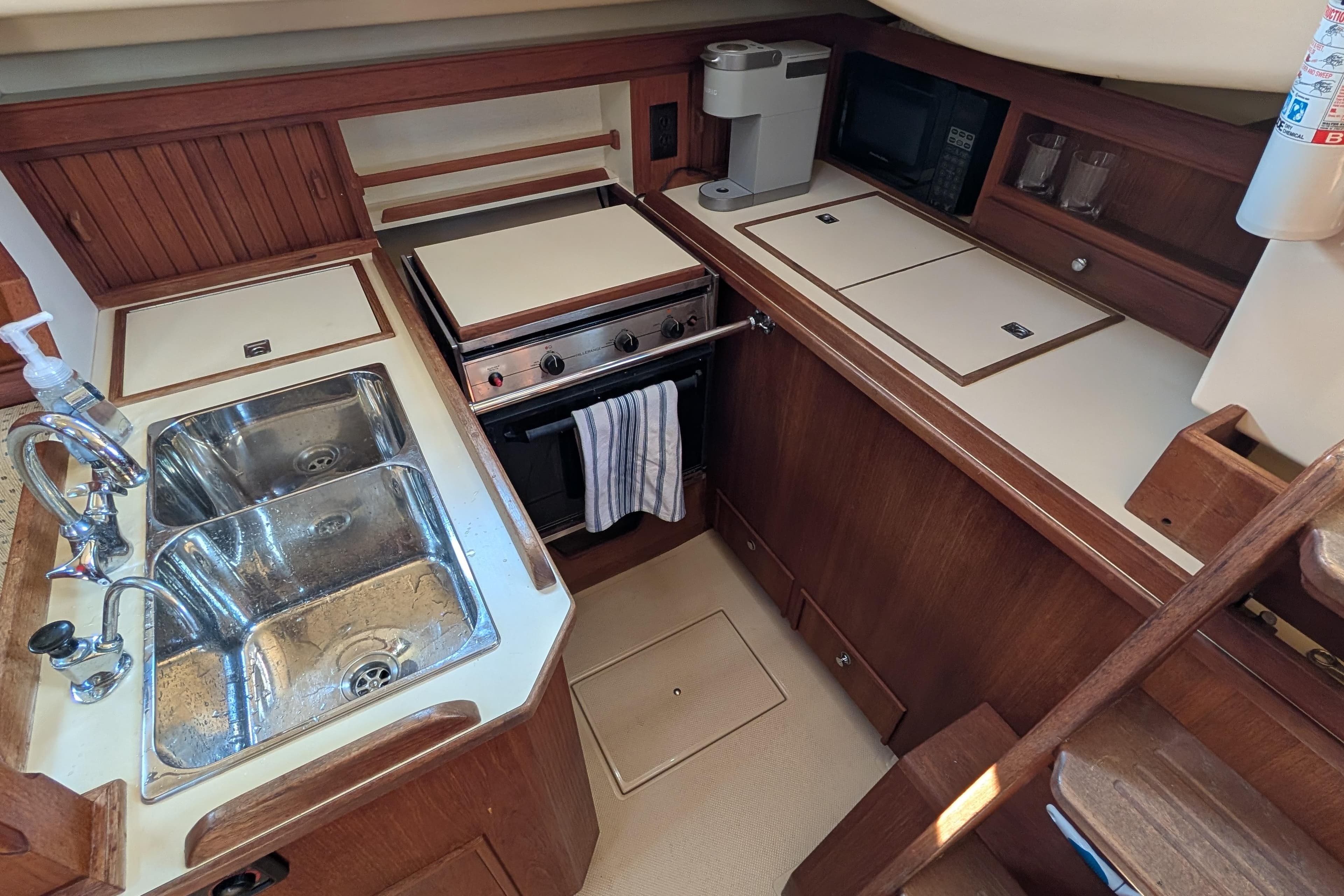 1999 Island Packet 320 yacht kitchen with sink, stove, and appliances.