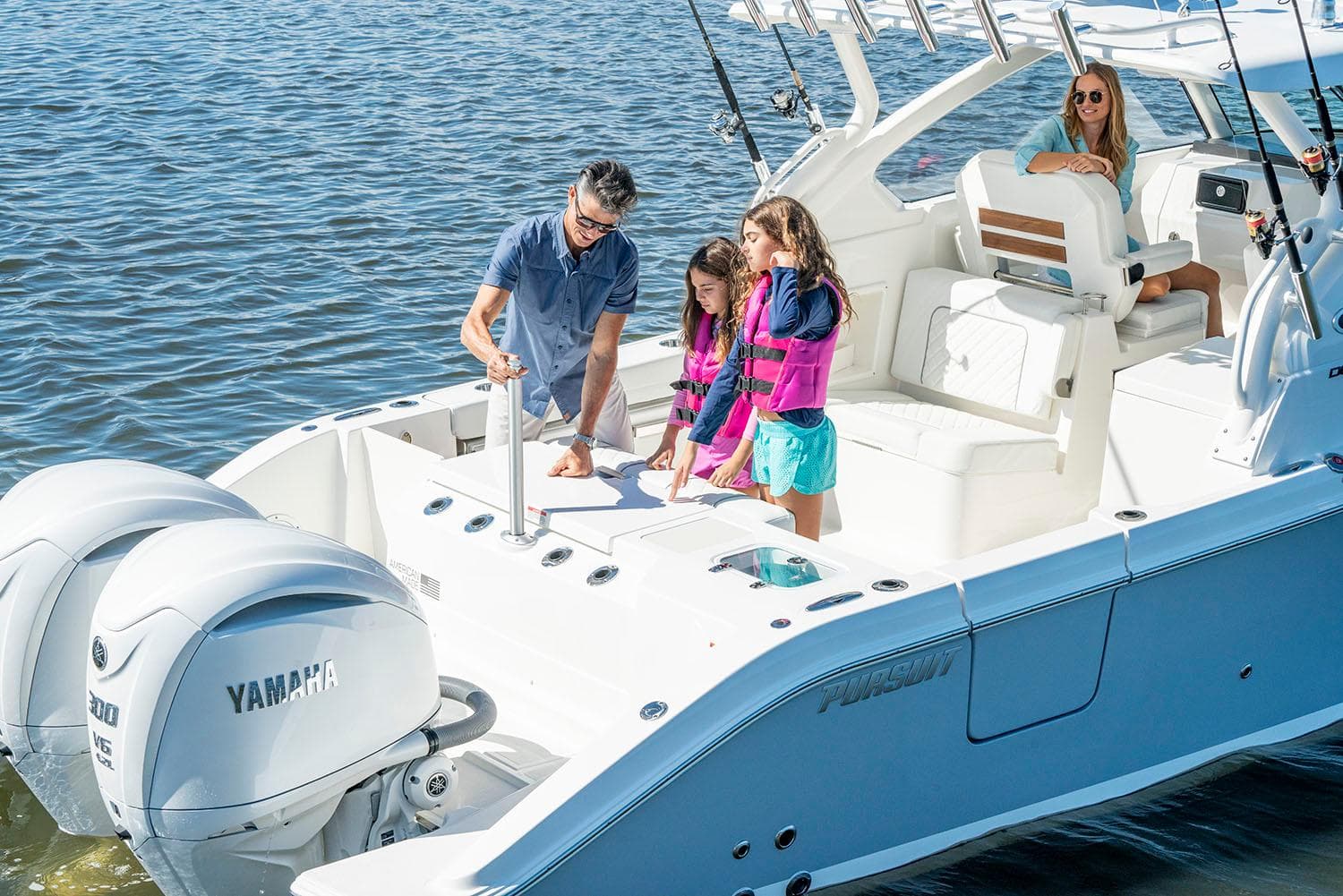 Manufacturer Provided Image: Family enjoying a 2025 Pursuit DC 306 Dual Console boat on the water.