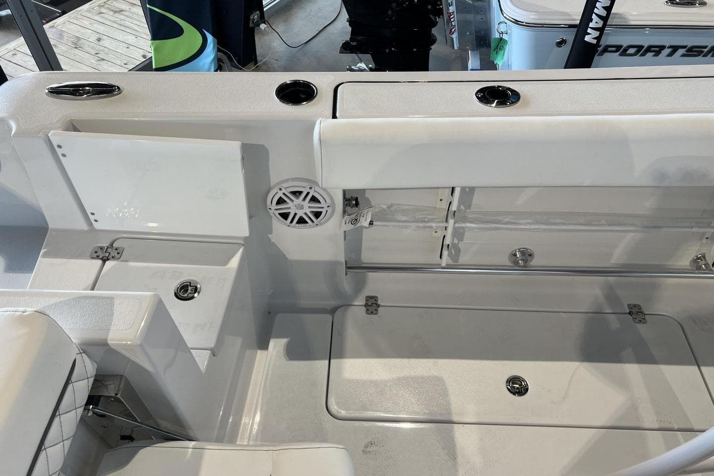 2025 Sportsman Open 252 Center Console boat interior with storage compartments and speaker.