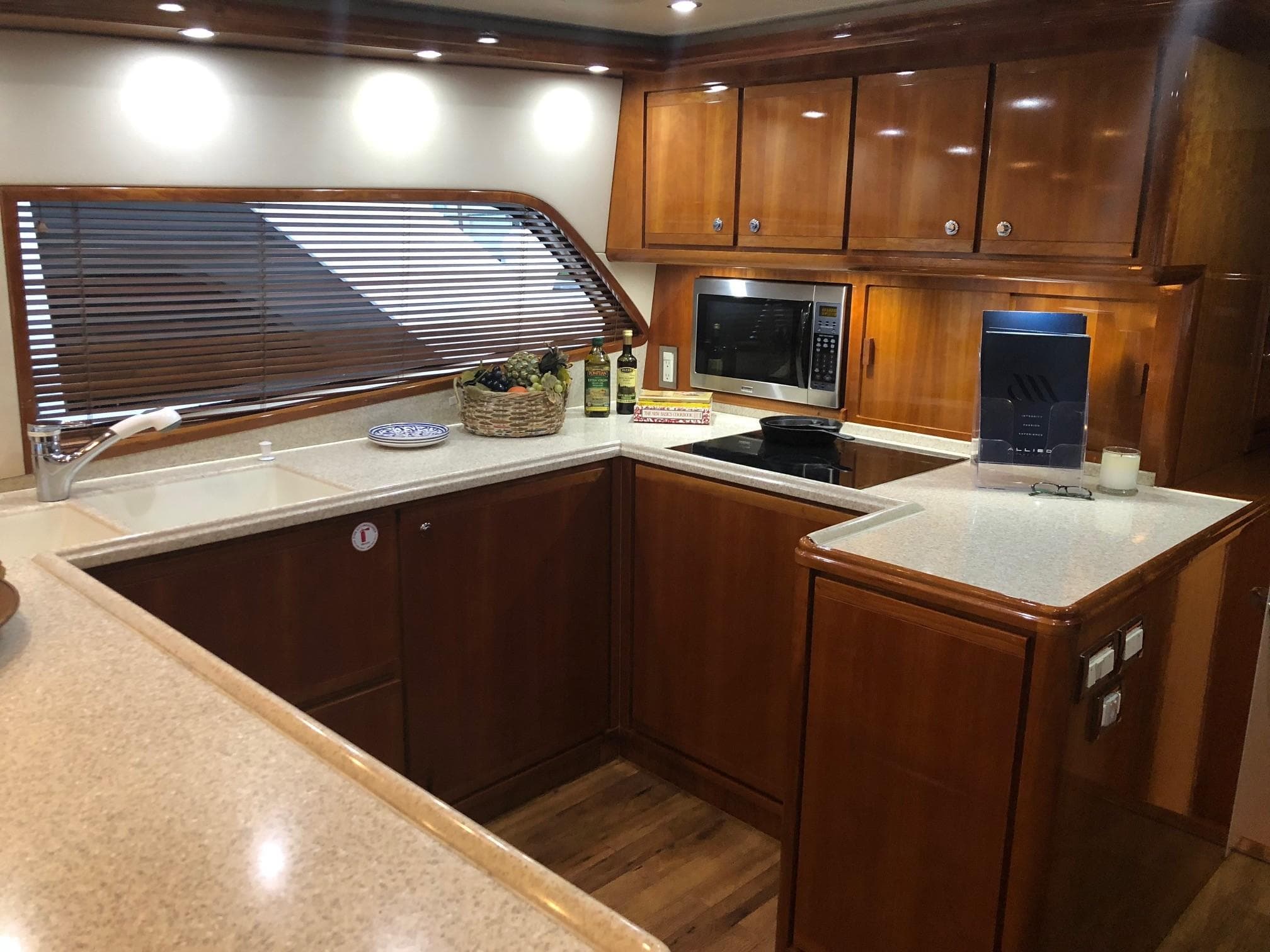 2004 Bertram 570 Convertible yacht kitchen with wooden cabinets and modern appliances.