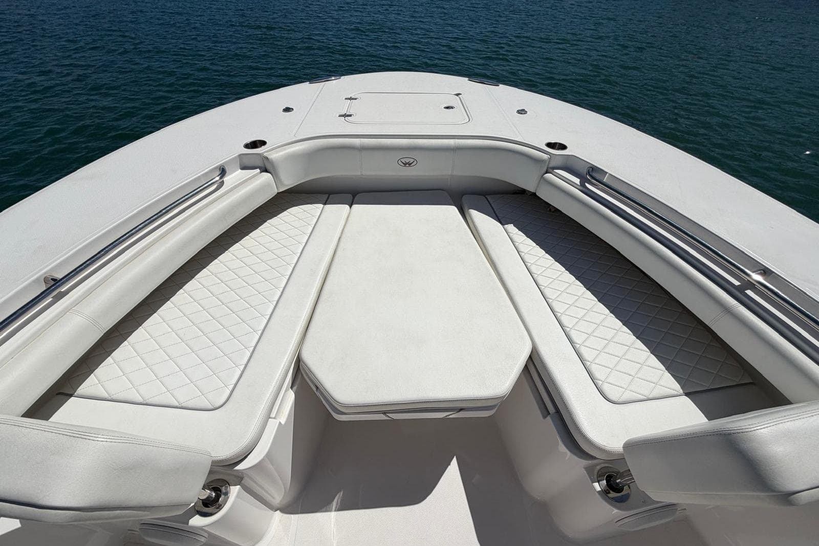 Bow seating area of a 2021 Southport 30 FE boat with quilted cushions.