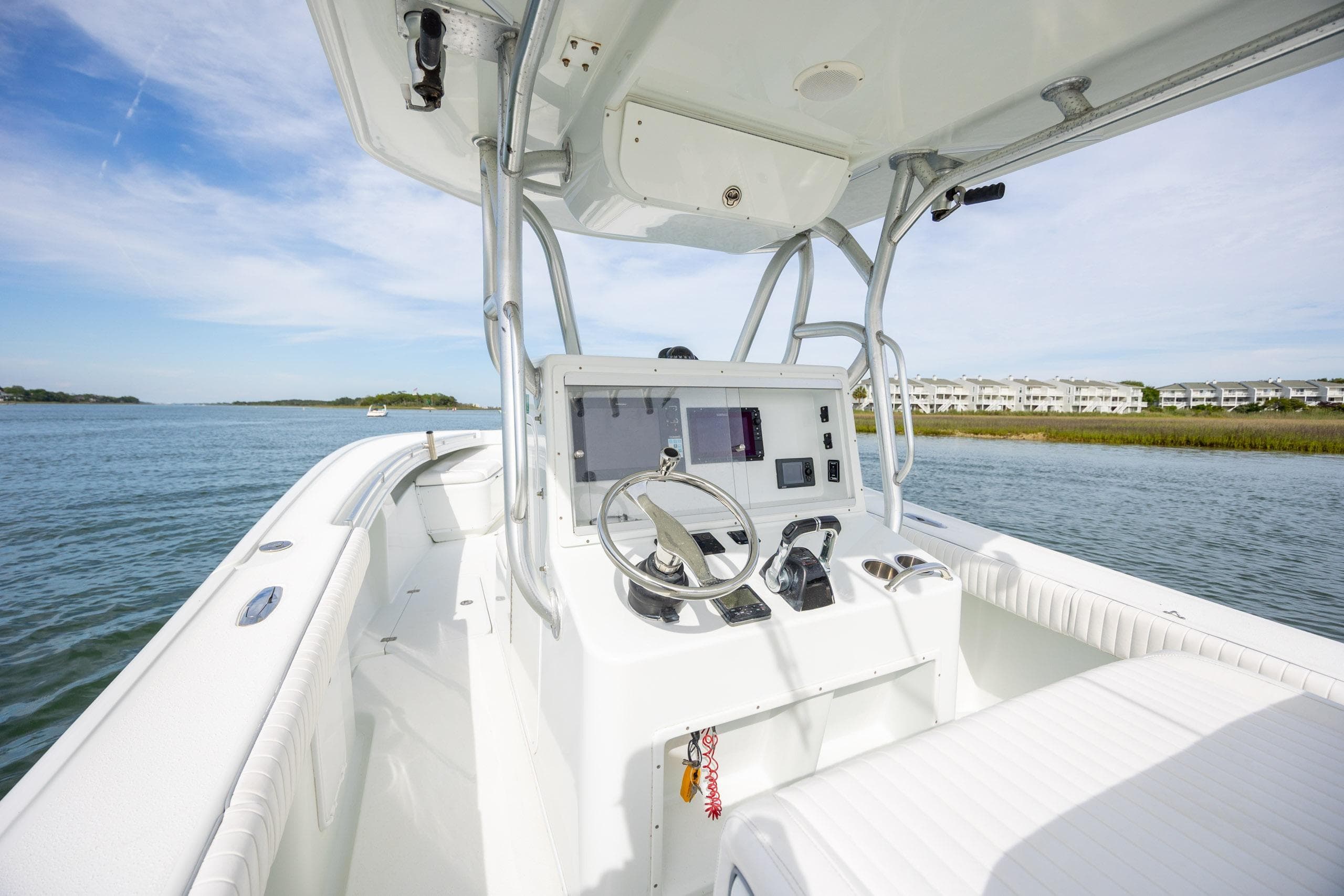 2013 Yellowfin 32 Offshore boat interior with steering console on calm water.