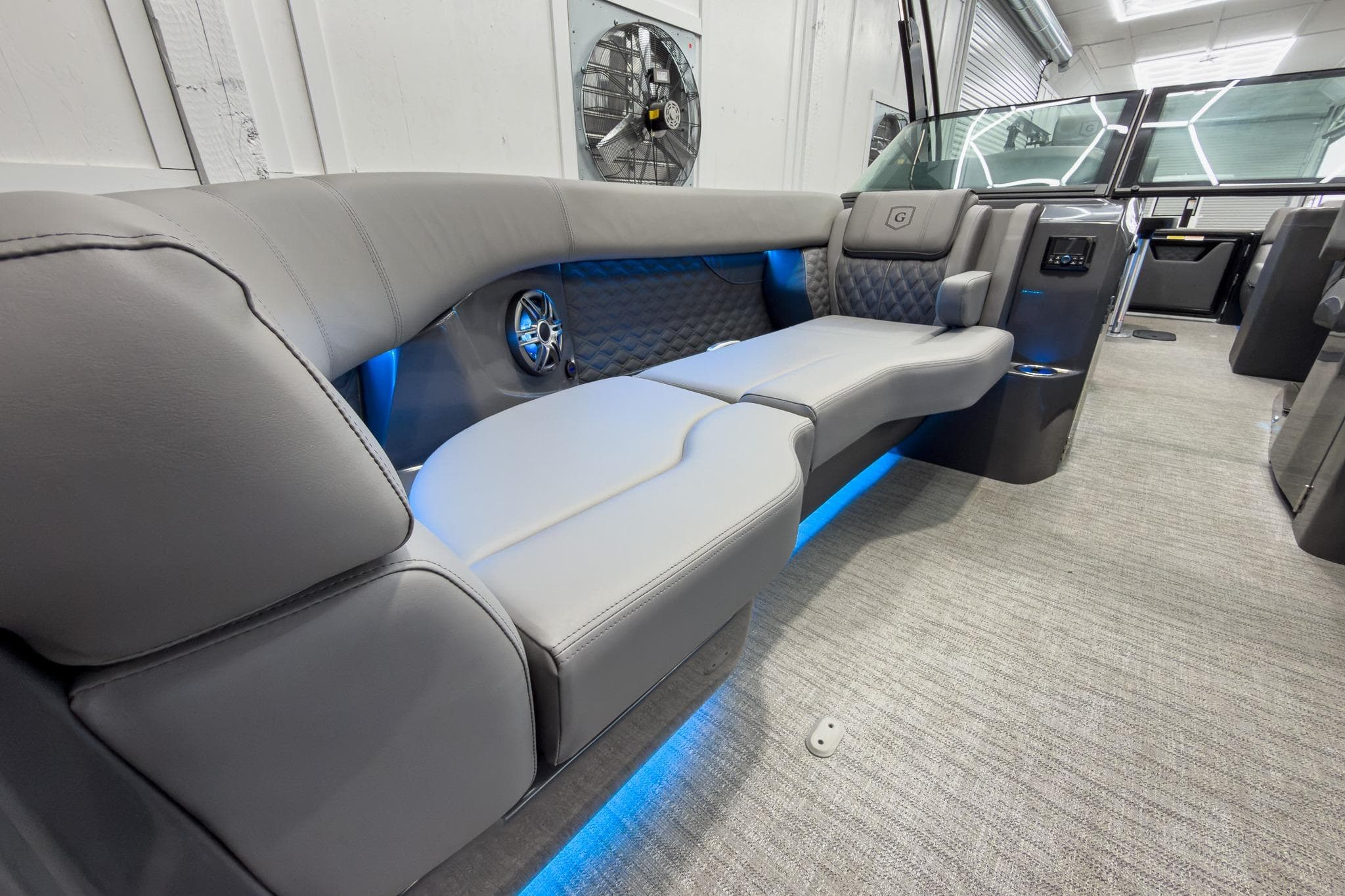 Luxurious interior of 2026 Godfrey Sanpan 27' Tritoon with plush seating and ambient lighting.