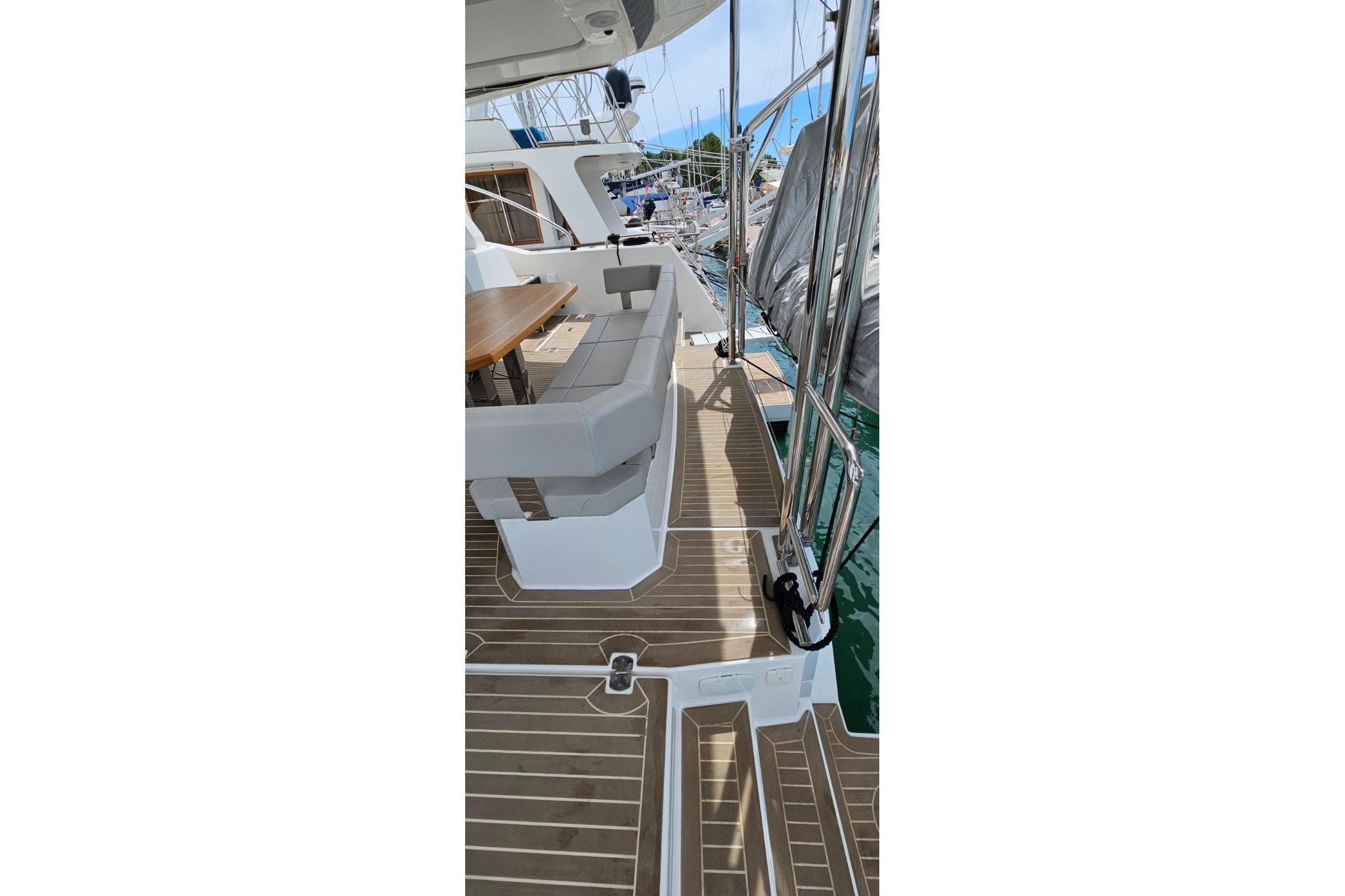 2023 Leopard 40 Powercat deck with seating and table, docked at marina.